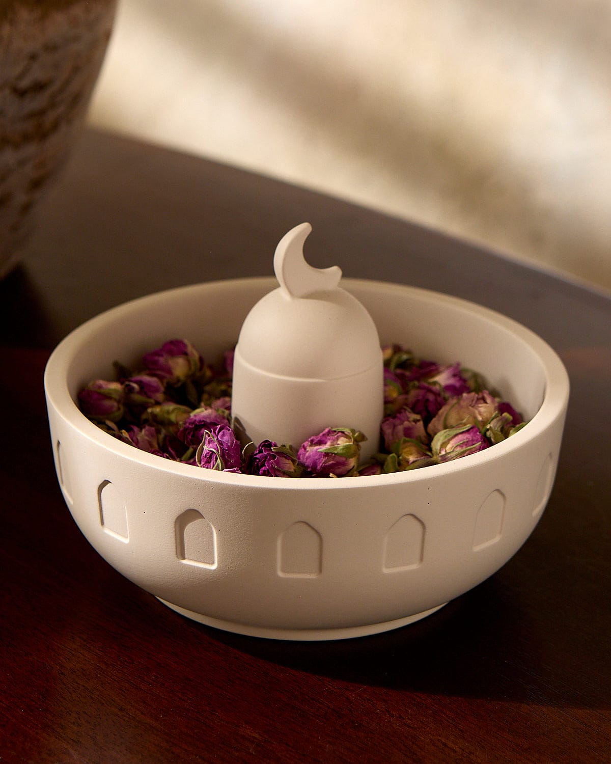 The Crescent Meze Bowl displayed containing dried pink rosebuds.