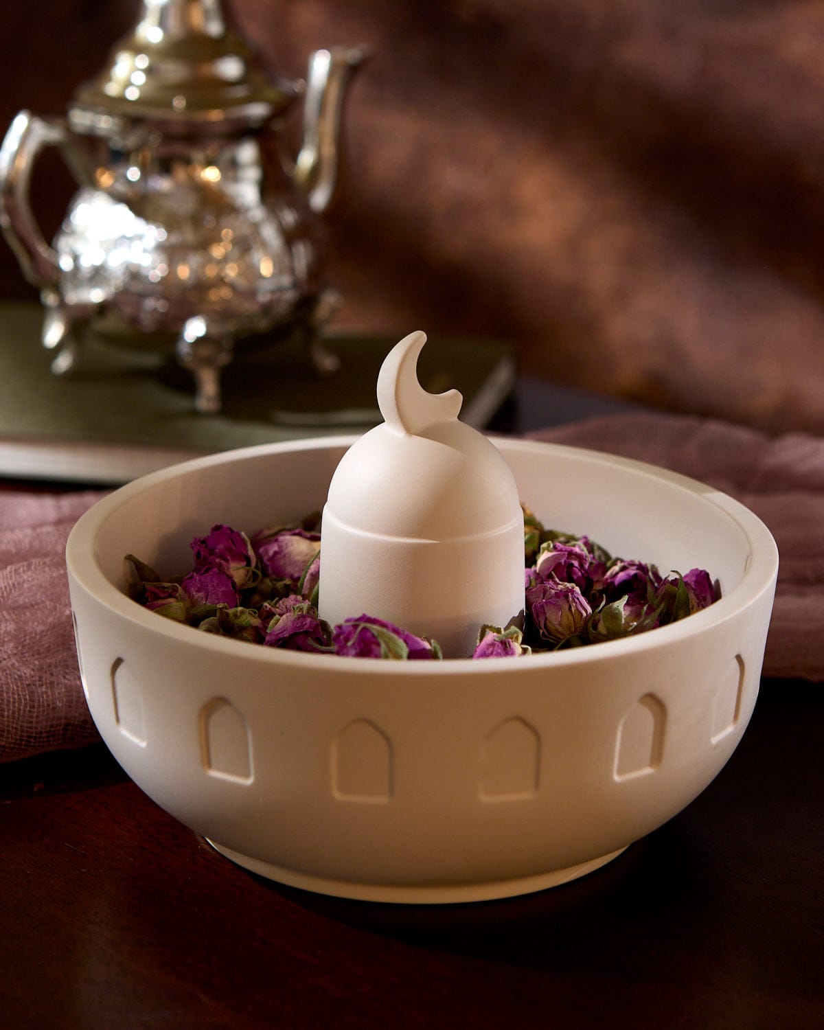 Close up of the Crescent Meze Bowl displayed containing dried pink rosebuds.