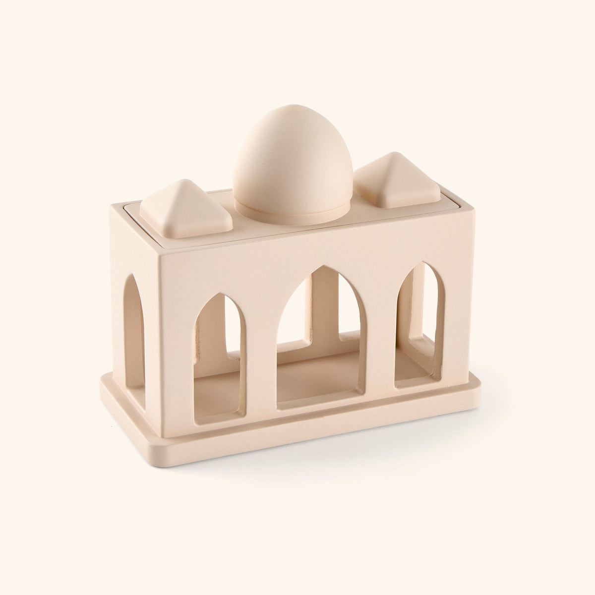 Sculpture of miniature corridor pulled from mosque architecture, complete with arched windows and domed roof, painted in beige. 