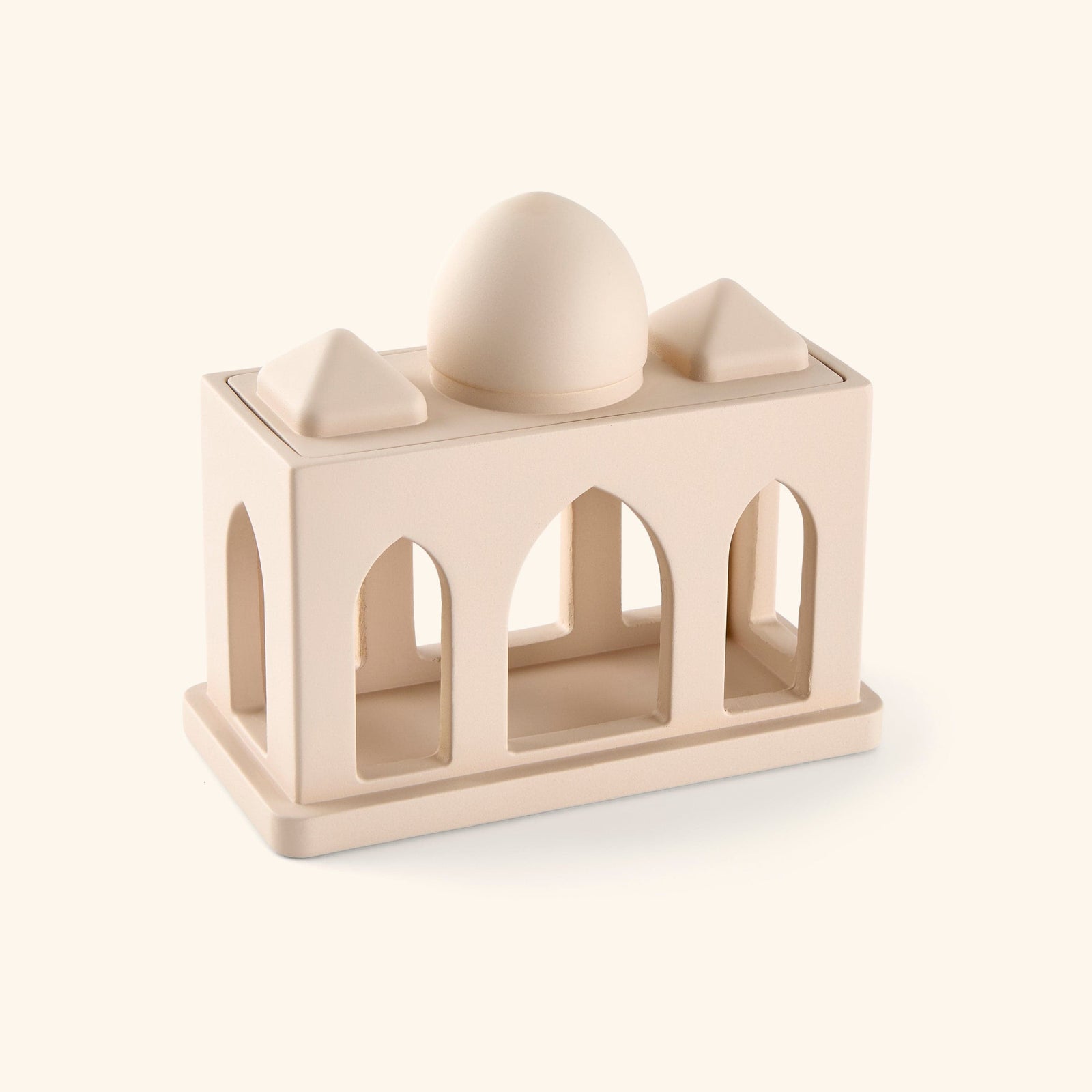 Sculpture of miniature corridor pulled from mosque architecture, complete with arched windows and domed roof, painted in beige. 