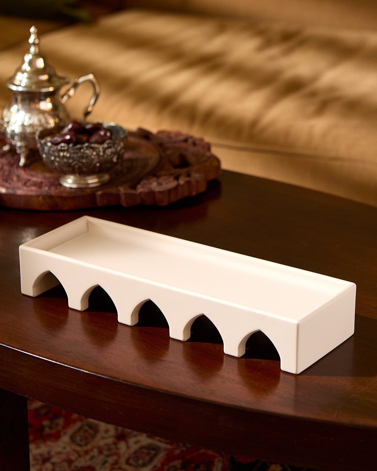 The Arches Decorative Sculpture displayed on top of a wood table.