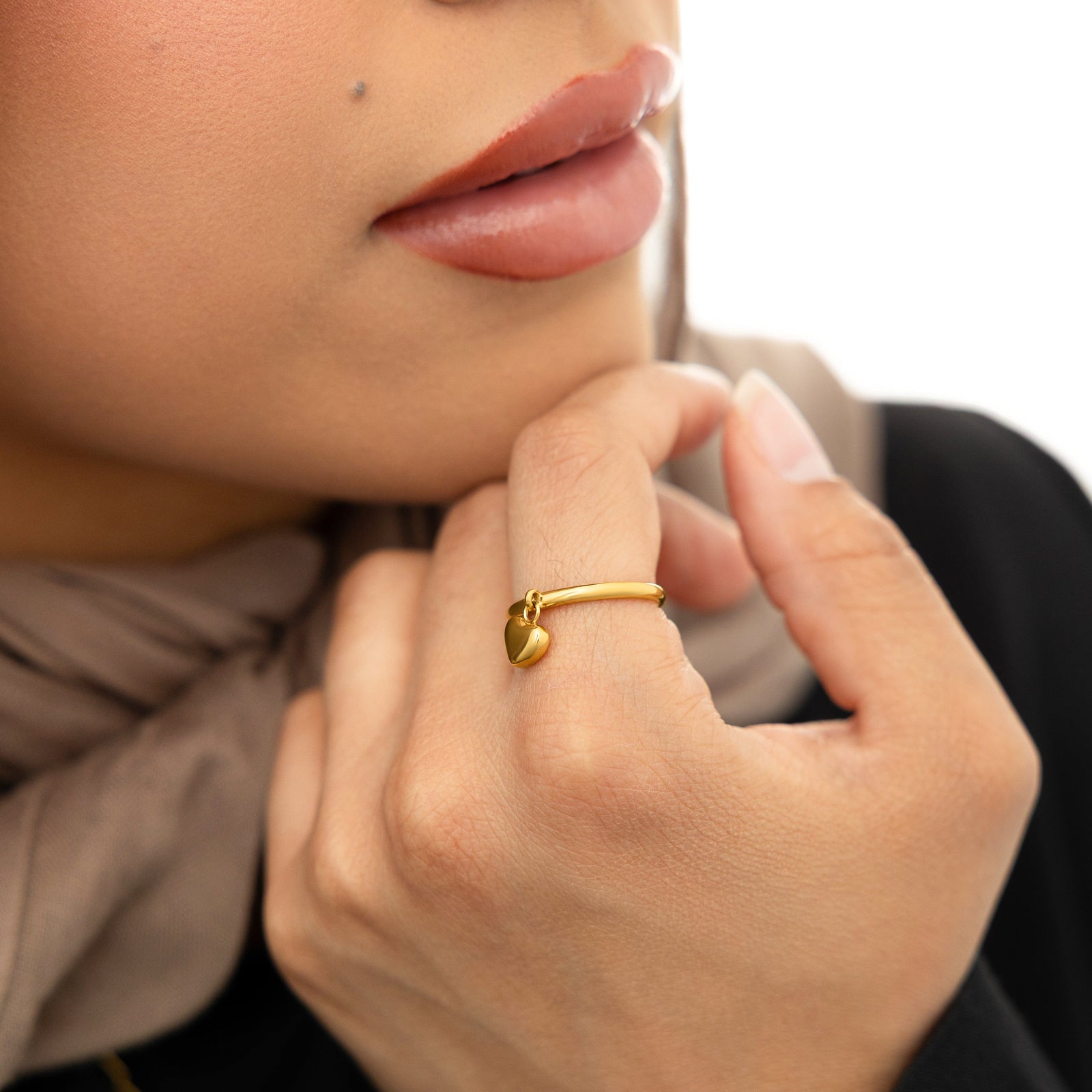 Woman wearing the gold Heart Loop Ring.