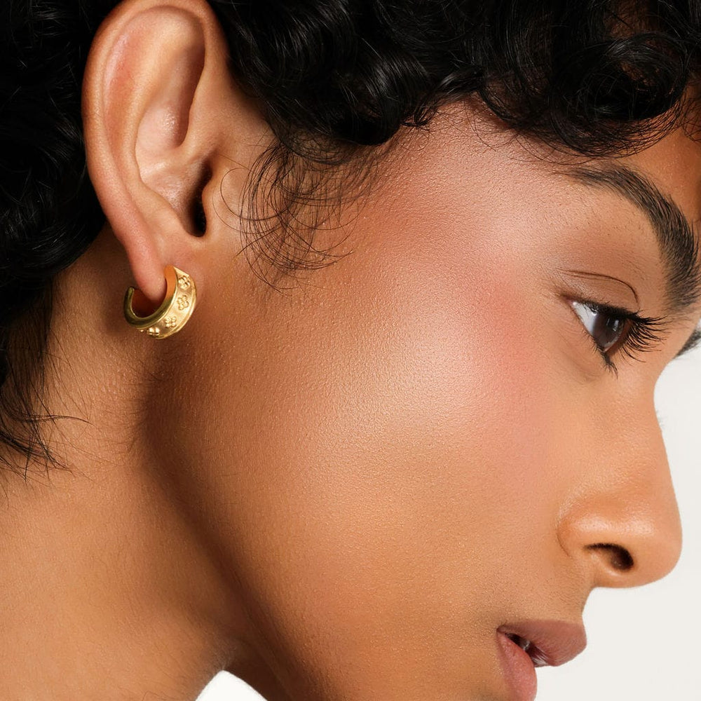 Photo of the right side of the model's face. The model is wearing the gold Henna Hoops on their right ear.