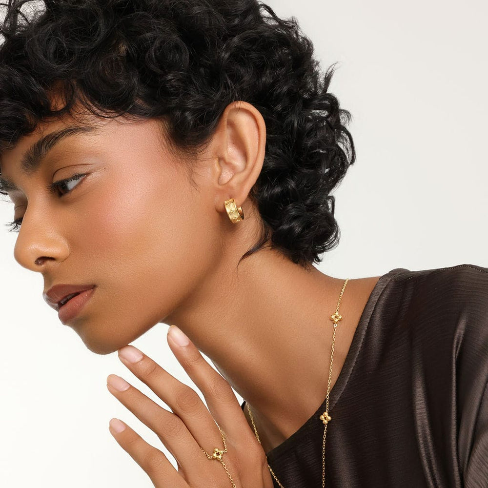 The gold Henna Hoops as worn by the model on their left ear.