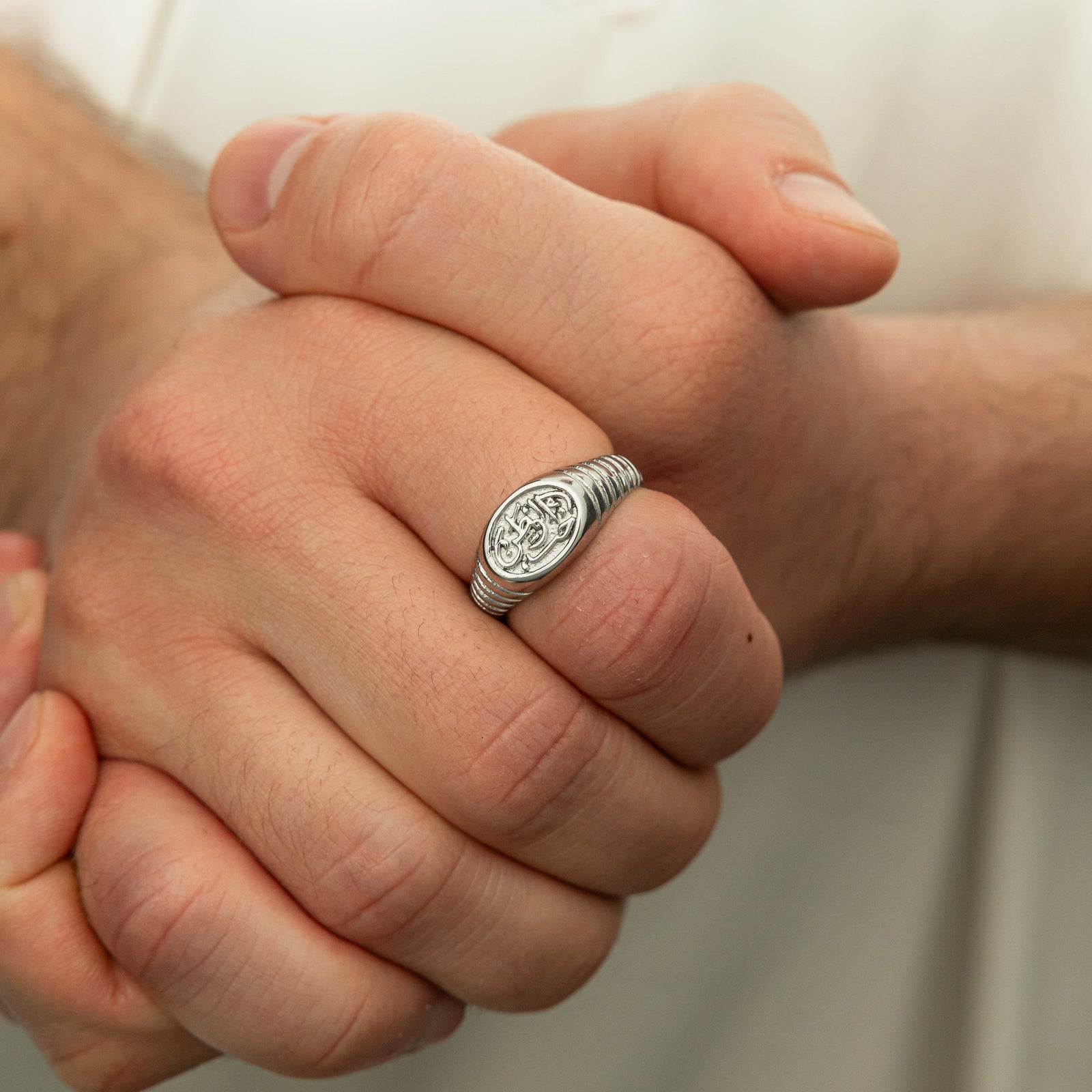 Photo of the model's clasped hands wearing the Homeland Ring | Men on their right index finger.
