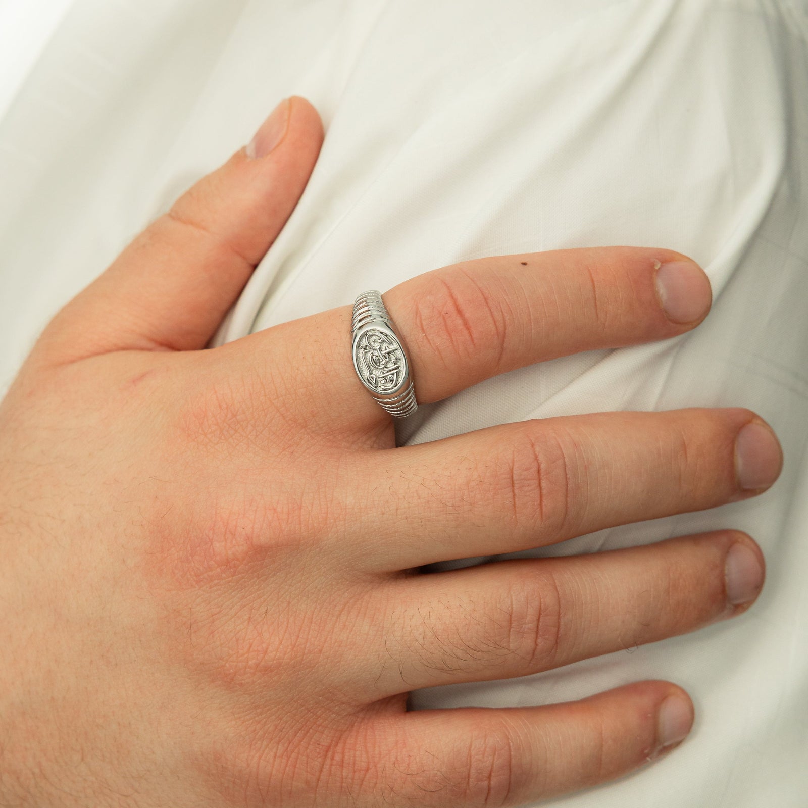 Close up of the model's hand wearing the silver Homeland Ring | Men on their right index finger.
