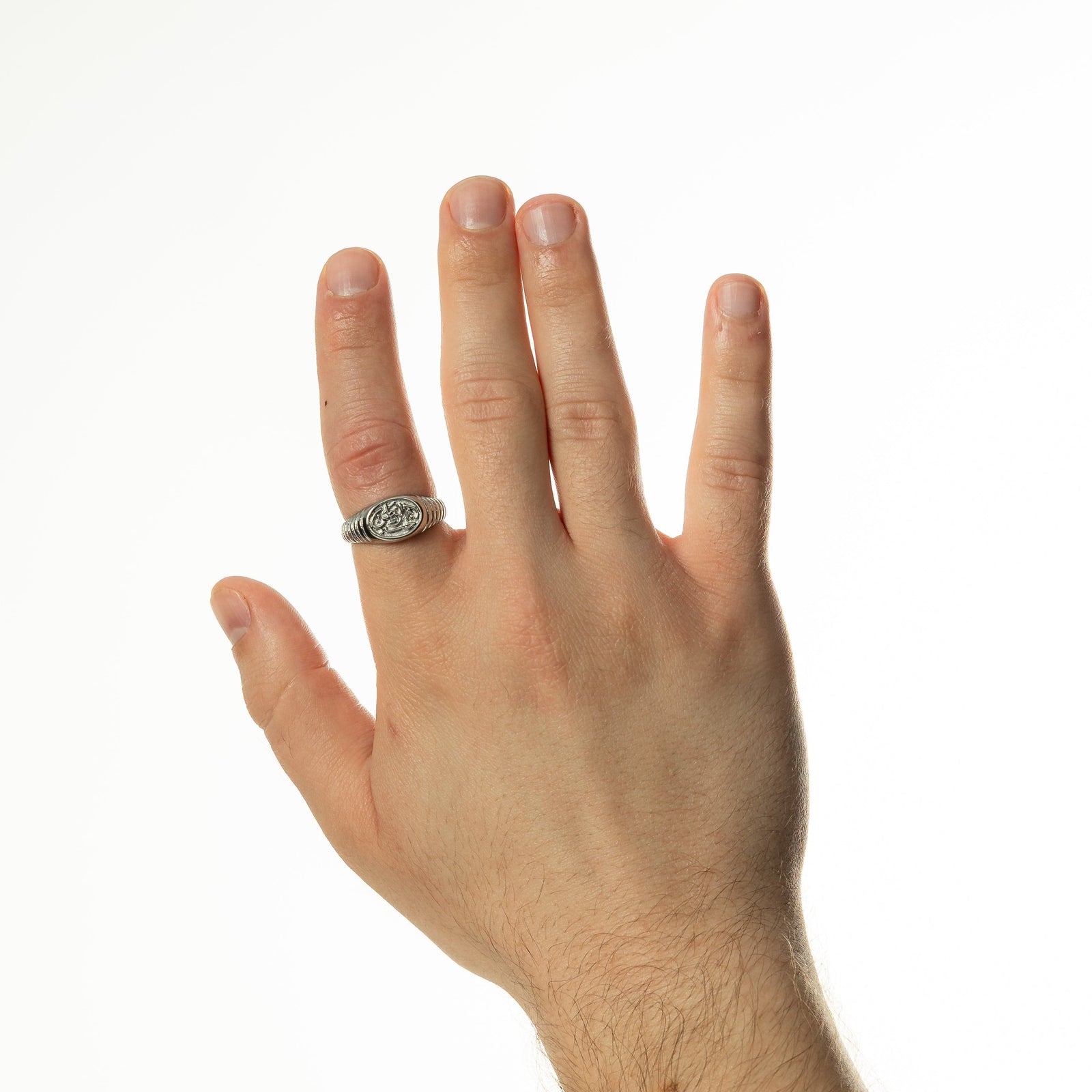 Photo of the model's right hand on a white background. Model is wearing the silver Homeland Ring | Men on their right index finger.