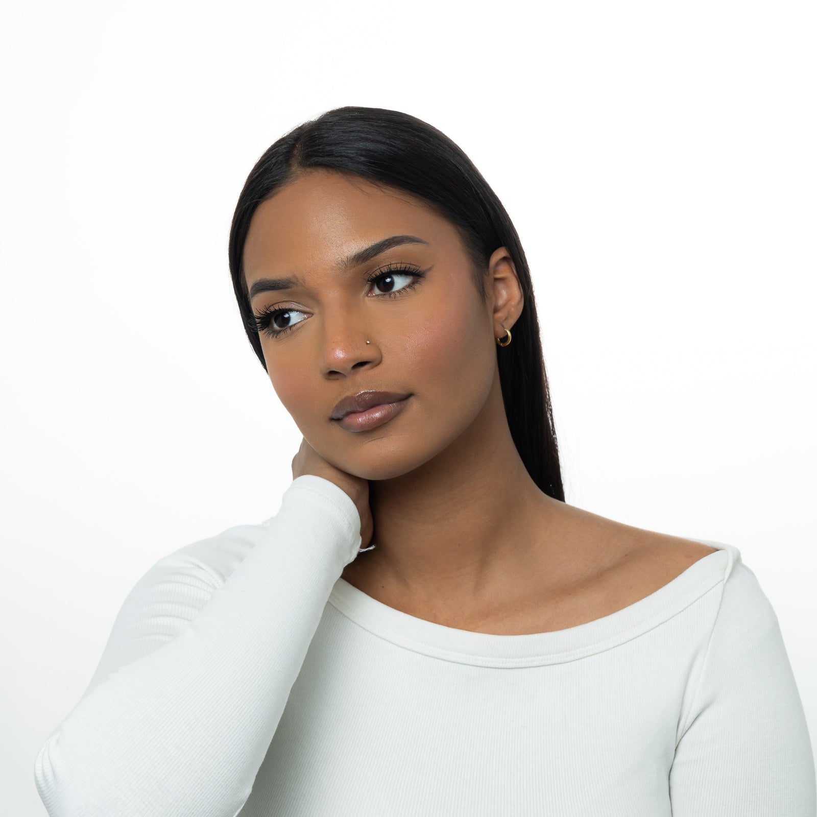 Photo of the model wearing the Huggie Essential Hoops | 8mm