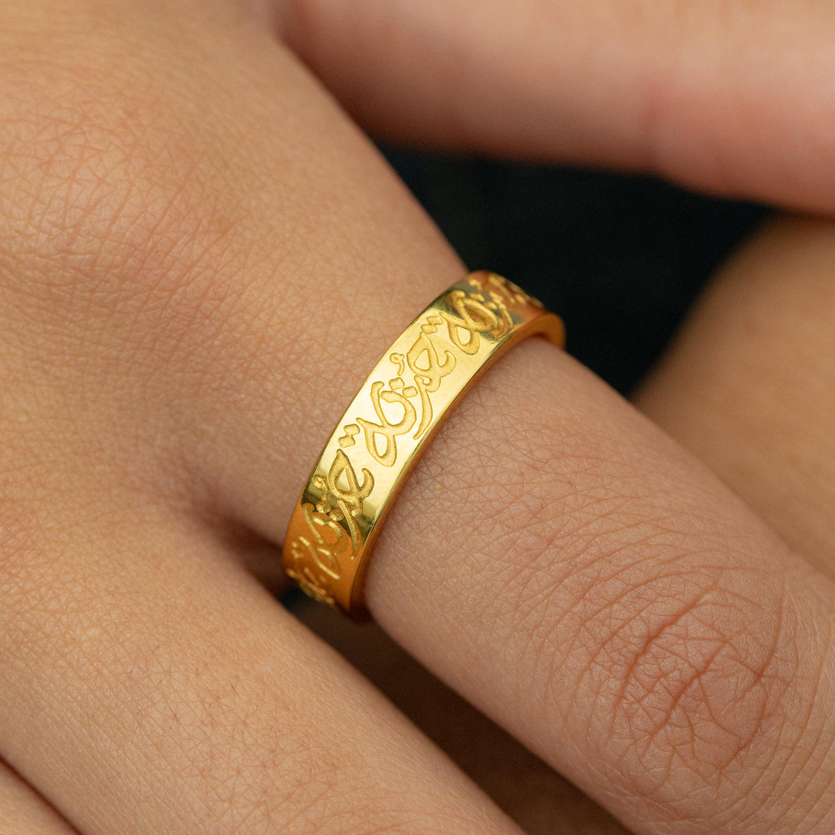 Close up of the gold “Hurriya” | Freedom Ring as worn by the model.