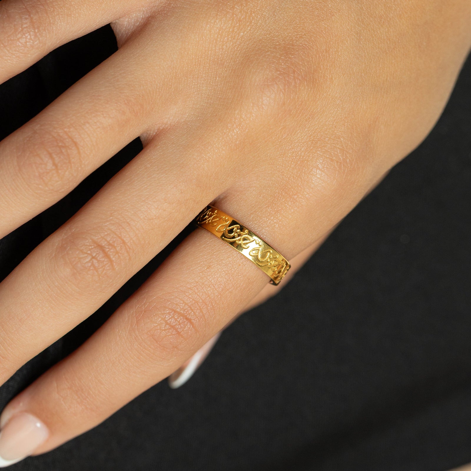 Close up of the gold “Hurriya” | Freedom Ring as worn by the model.