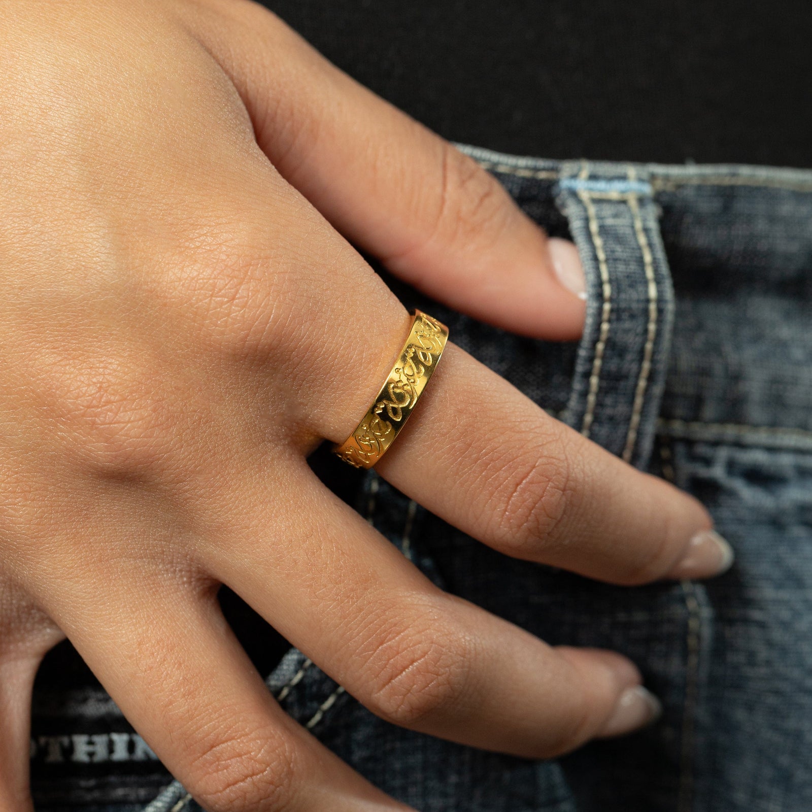 Close up of the gold “Hurriya” | Freedom Ring as worn by the model.
