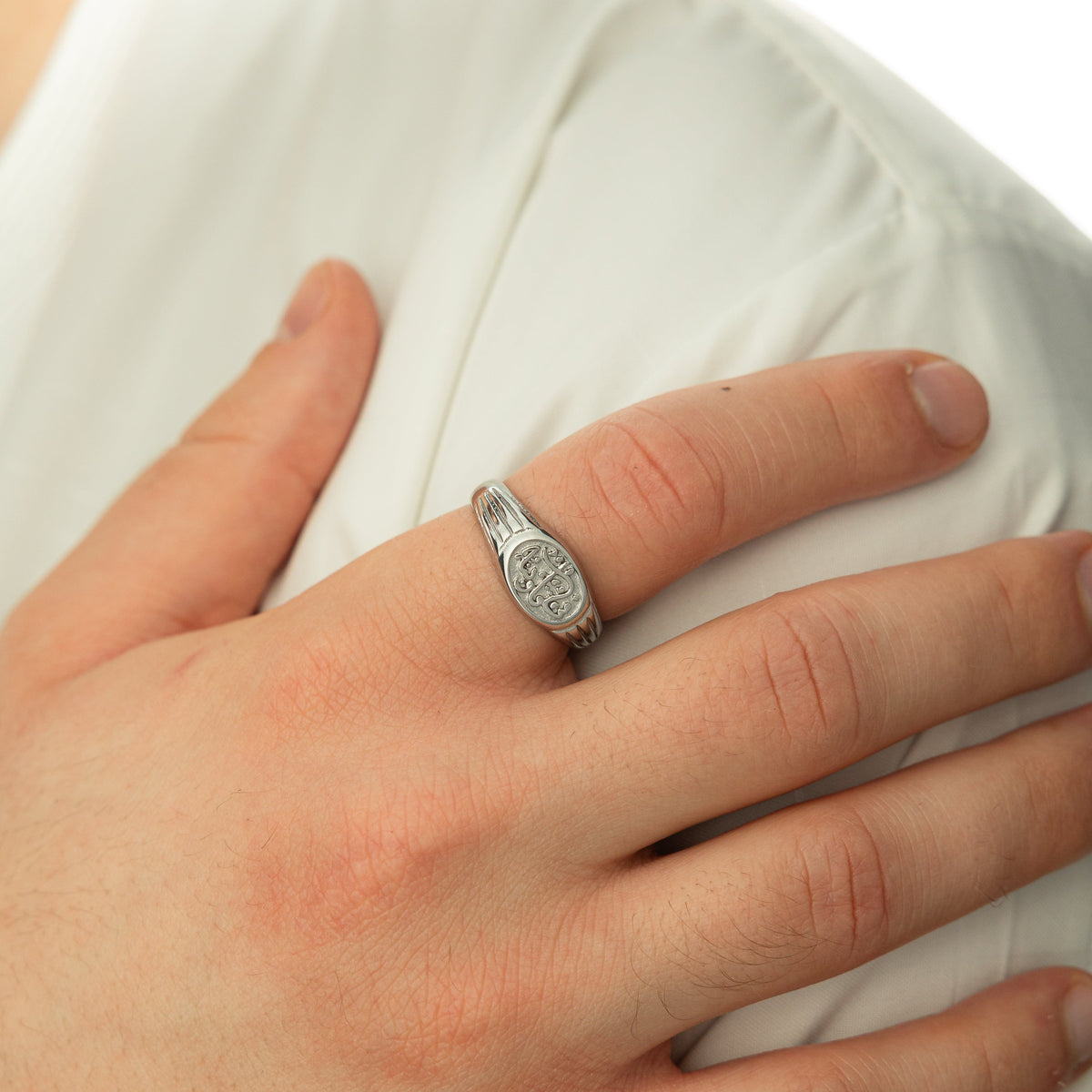 Close up of the model's hand wearing the silver In Our Hearts Vintage Ring | Men on their right index finger.