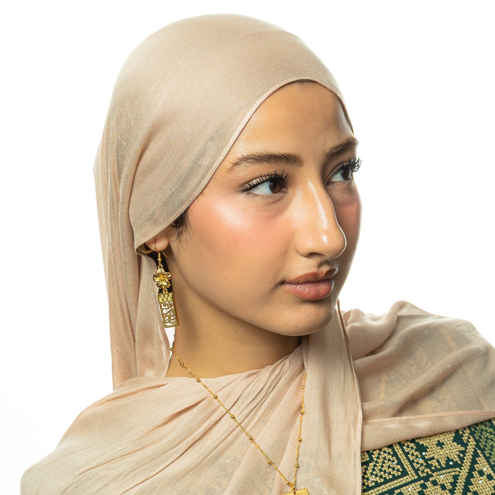 Picture of the model wearing the gold In Our Hearts Damascus Earrings.