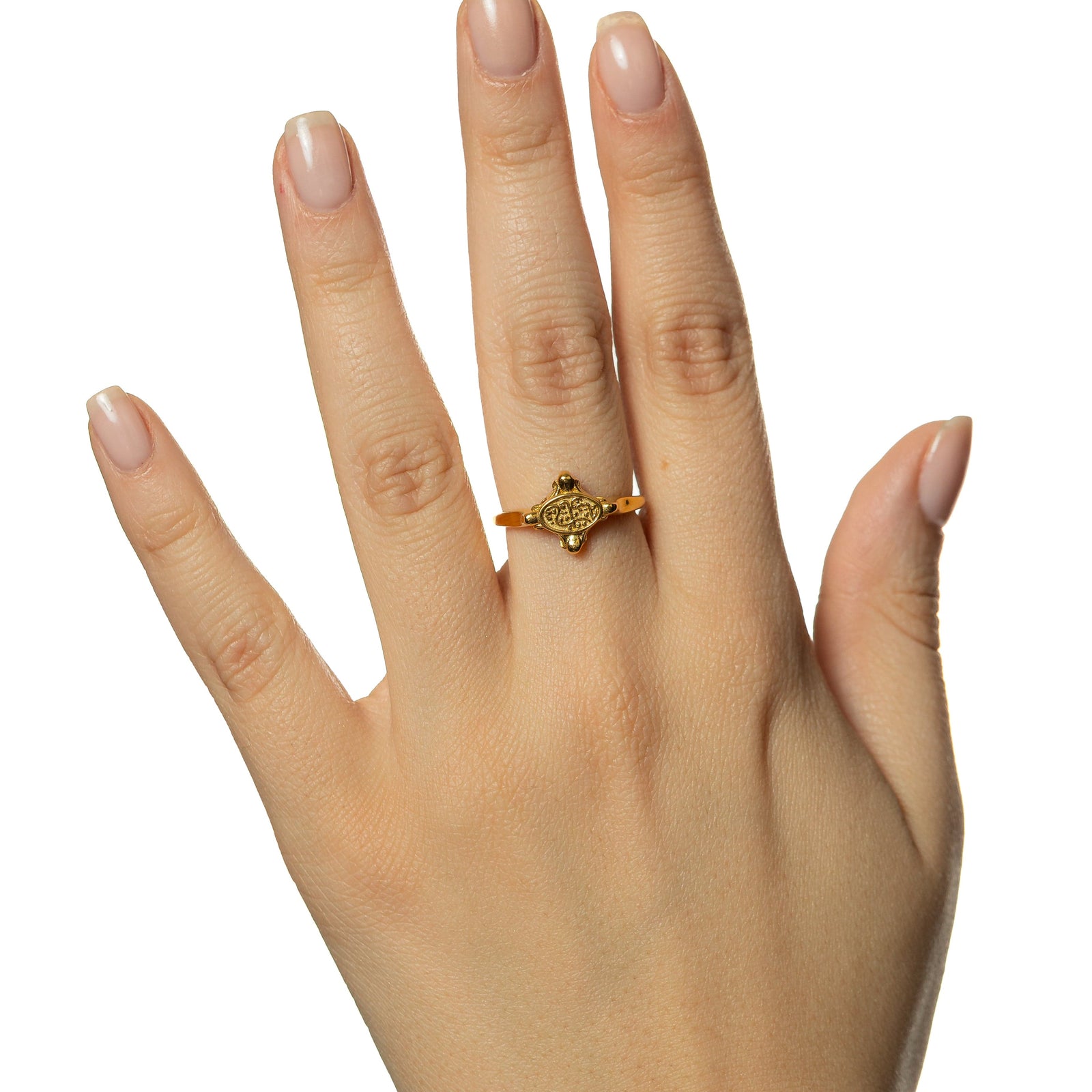 Picture of the model's hand wearing the gold In Our Hearts Vintage ring.