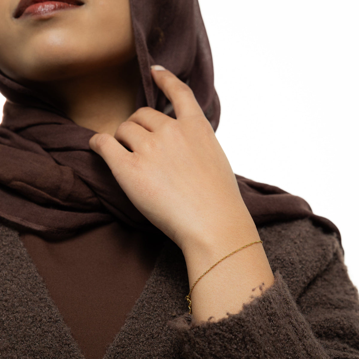 Photo of the model wearing the gold Micro Twisted Bracelet.