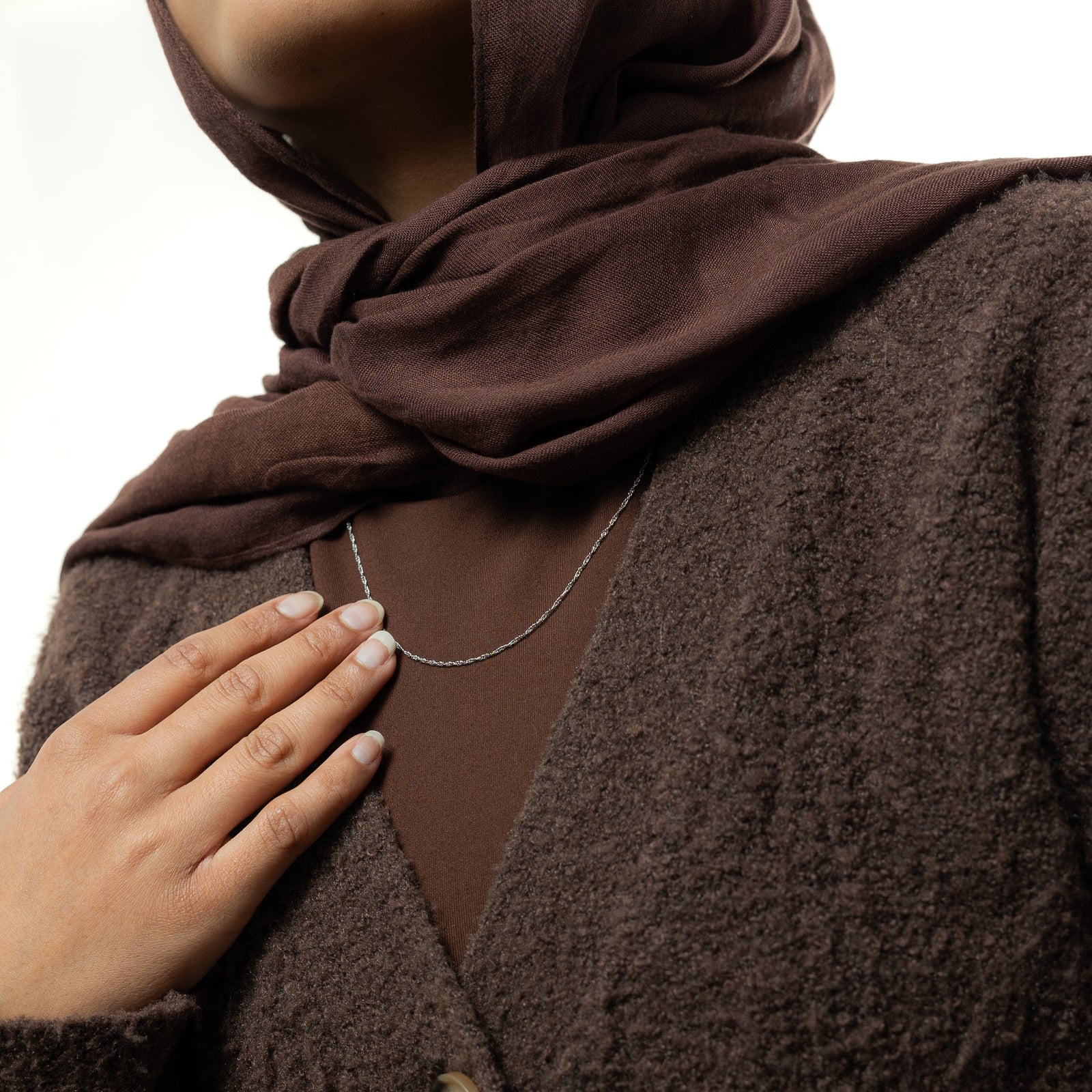 Close up of the silver Micro Twisted Chain as worn by the model.
