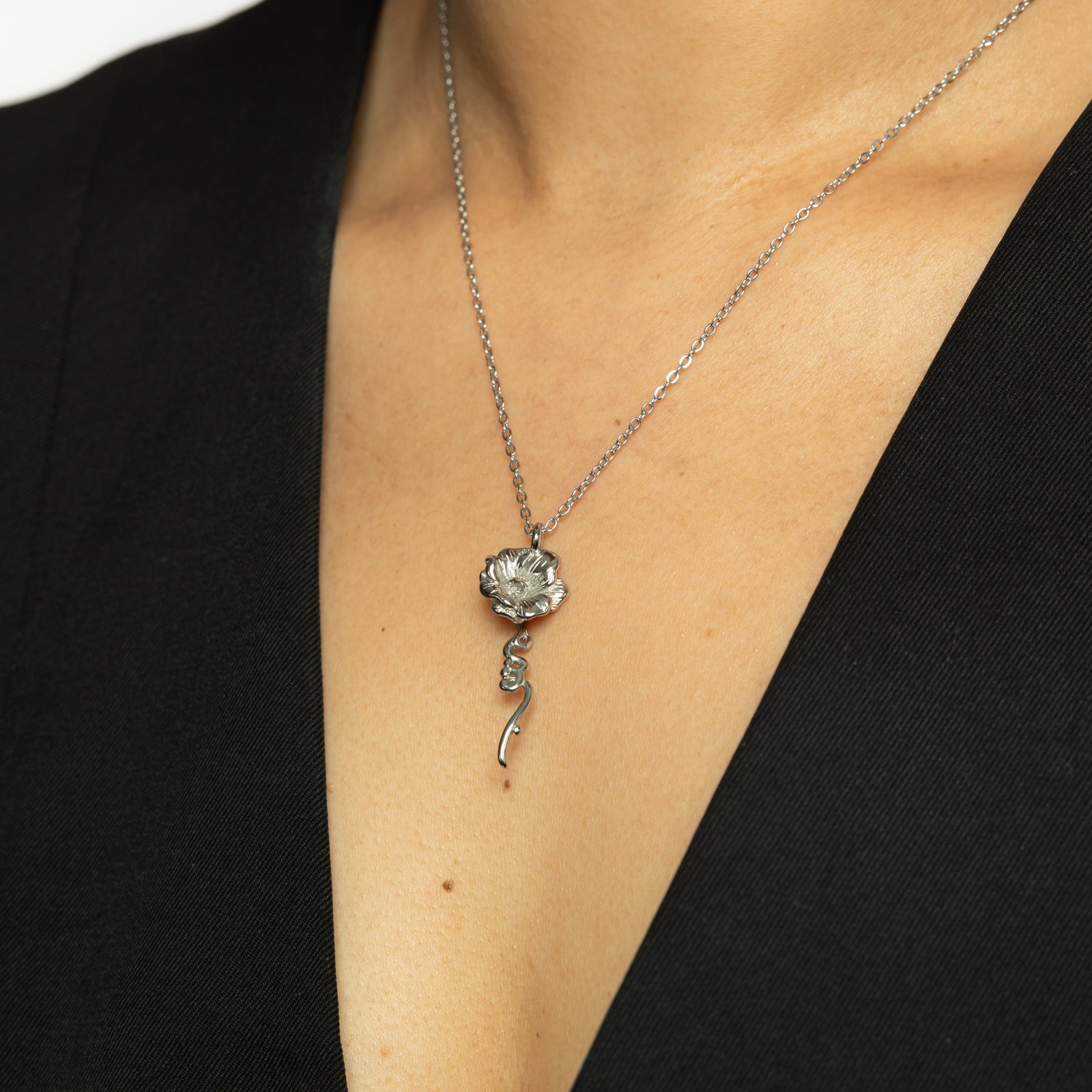 Close up of the silver It's Written' Anemone Necklace as worn by the model.