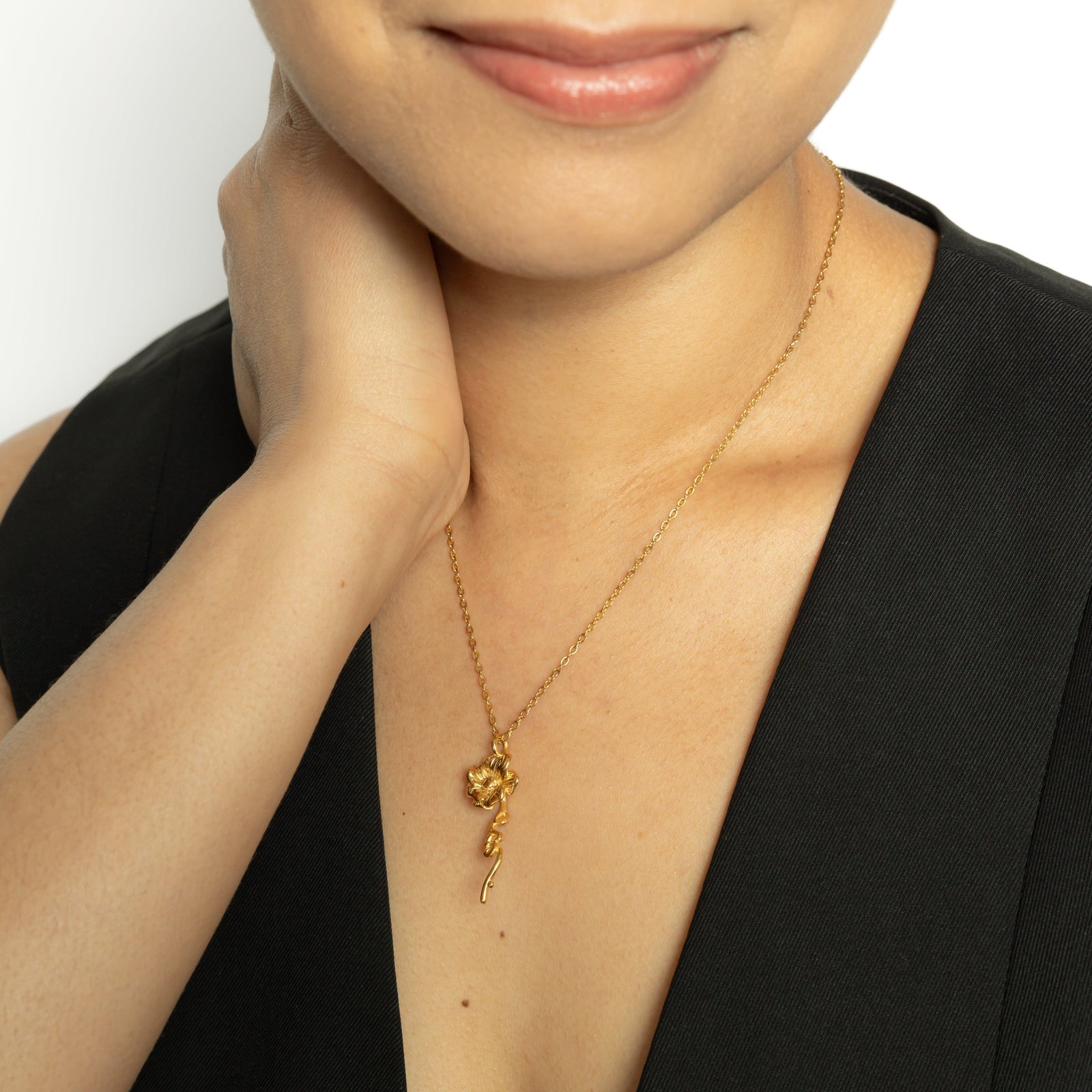 Close up of the gold It's Written' Anemone Necklace as worn by the model.