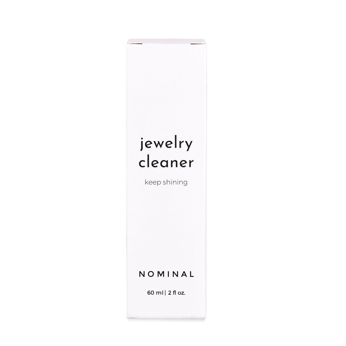 White rectangular box of Nominal Jewelry Cleaner with black text reading “jewelry cleaner, keep shining” and “NOMINAL 60 ml | 2 fl oz.”