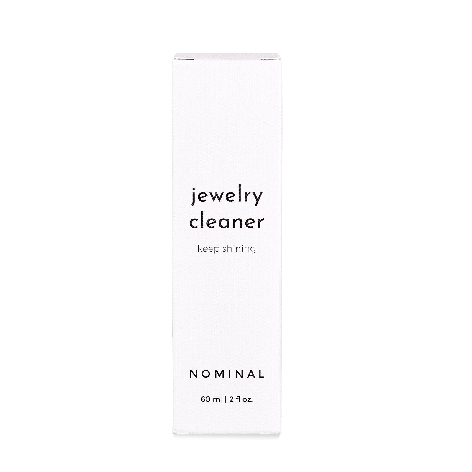 White rectangular box of Nominal Jewelry Cleaner with black text reading “jewelry cleaner, keep shining” and “NOMINAL 60 ml | 2 fl oz.”