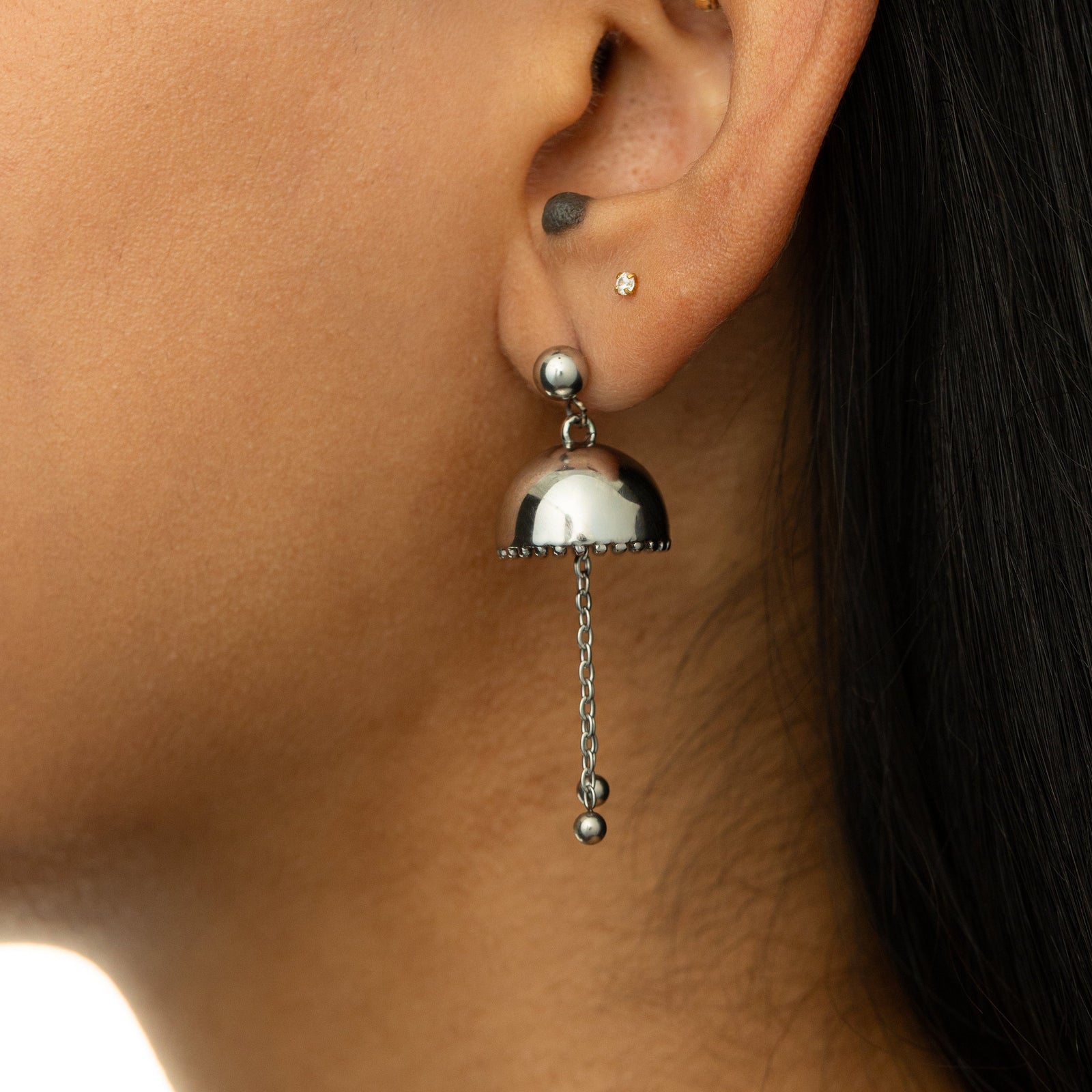 Silver Jhumka Earring with dome top and chain drops, styled on ear.
