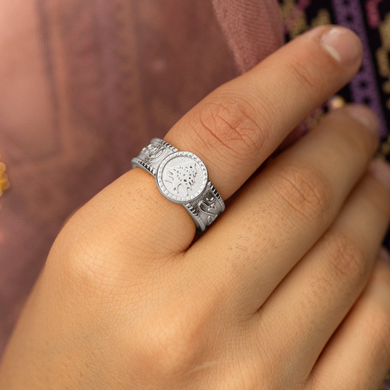 Close up photo of the silver Lebanon Freedom is the Soul ring as worn by the model on their index finger.