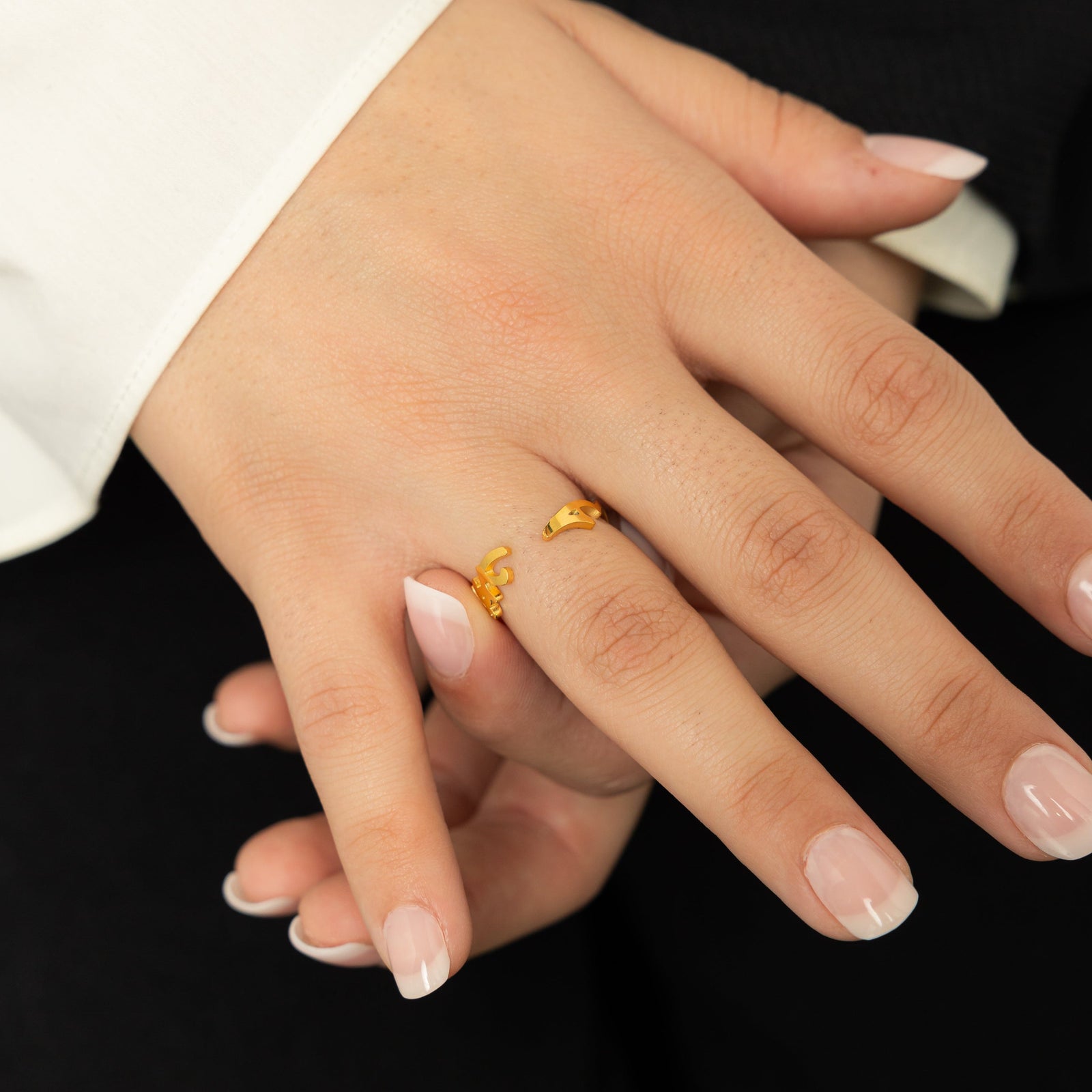 Person wearing a gold "Love Yourself First" ring on the ring finger, showing the ring’s open-ended design.