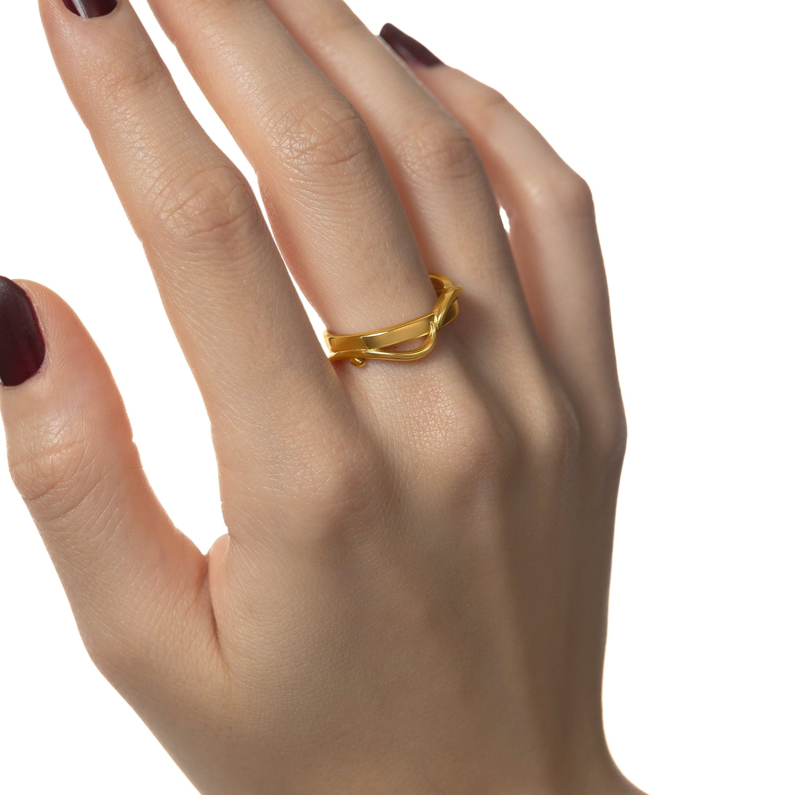 Photo of the model's right hand, gold Love | حب Intertwined Ring on their right middle finger.