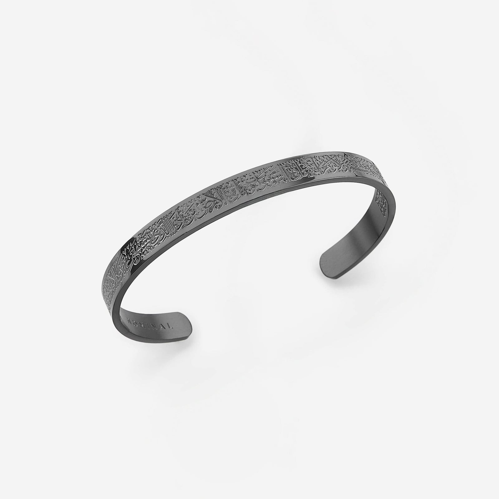 Photo of a black cuff  engraved entirely on the front and continuing onto the back to offer a beautifully intricate aesthetic