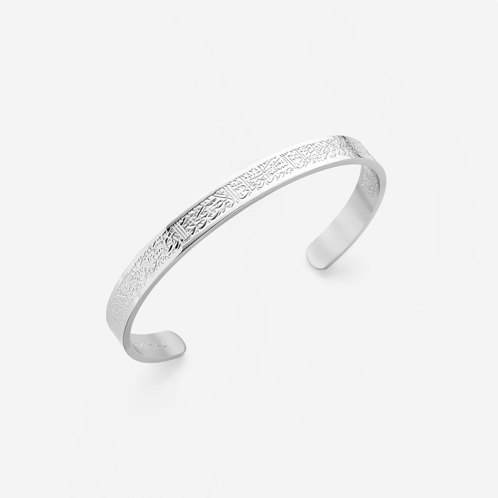 Photo of a silver cuff  engraved entirely on the front and continuing onto the back to offer a beautifully intricate aesthetic