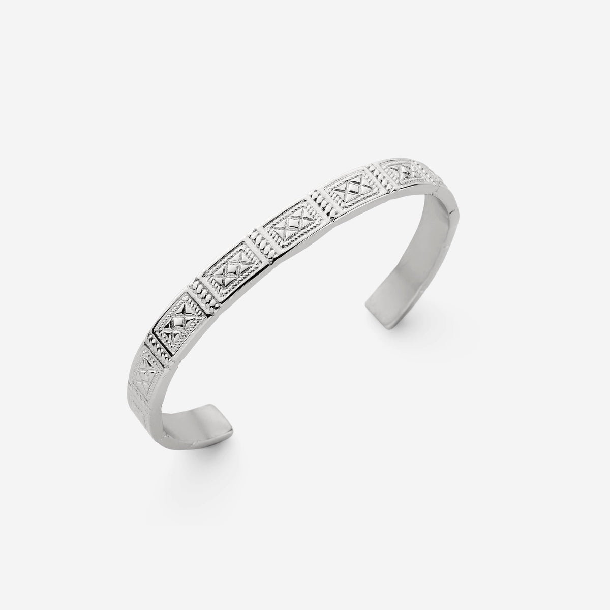 Silver cuff bracelet with engraved geometric square patterns and textured detailing on a plain light background.