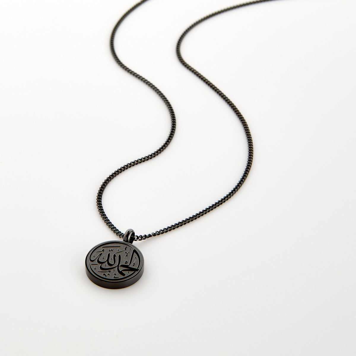 Black necklace with a circular pendant engraved with 'Alhamdulillah' calligraphy, displayed on a white background