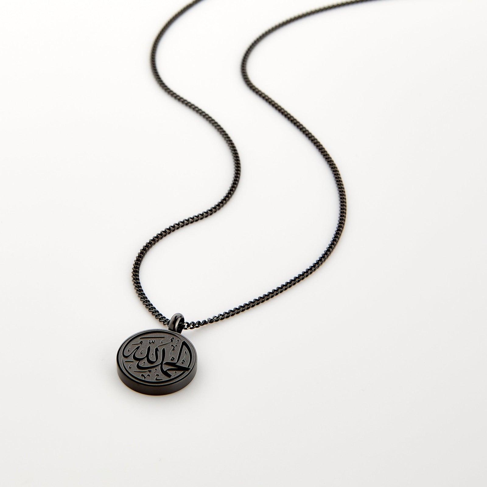 Black necklace with a circular pendant engraved with 'Alhamdulillah' calligraphy, displayed on a white background