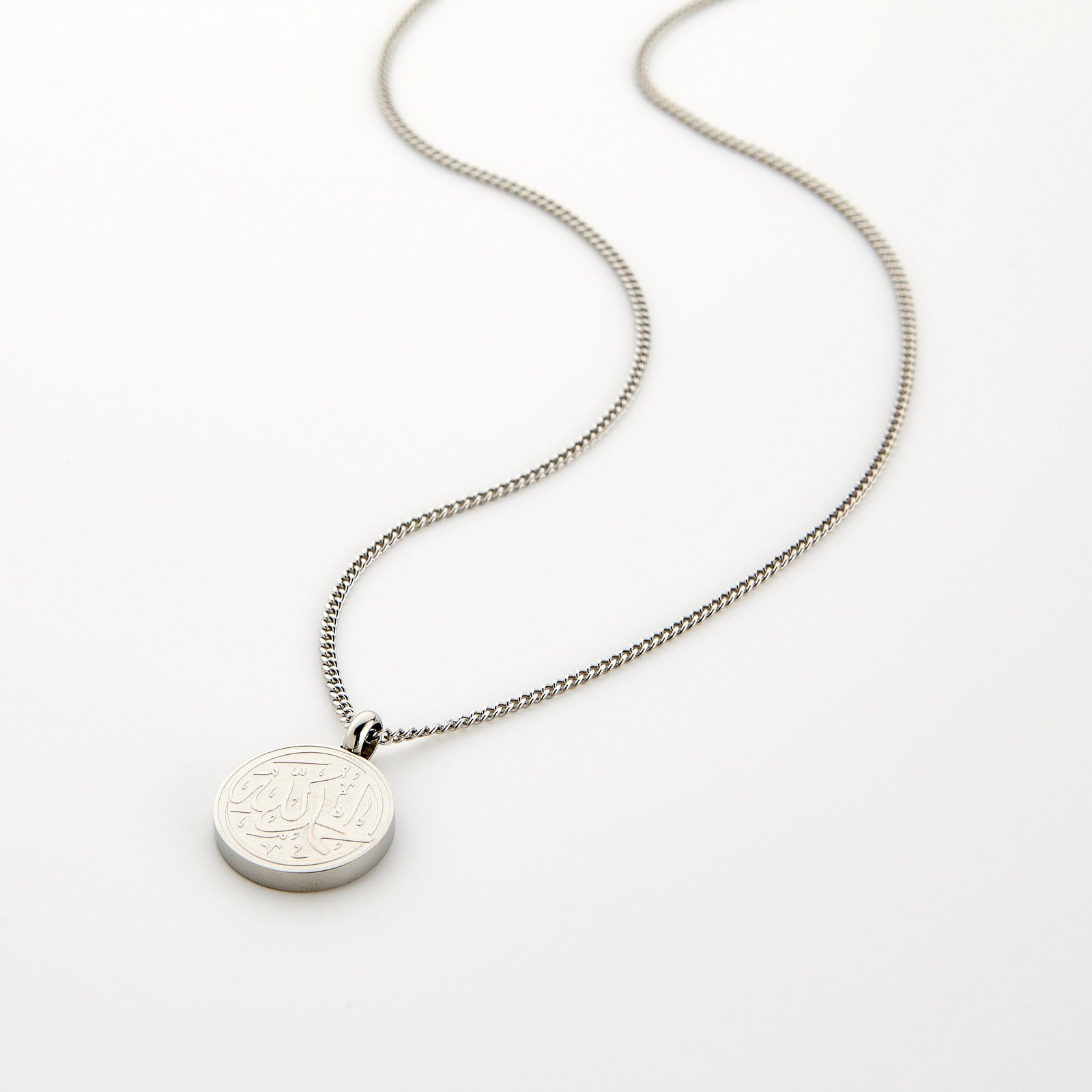 Silver necklace with a circular pendant engraved with 'Alhamdulillah' calligraphy, displayed on a white background.