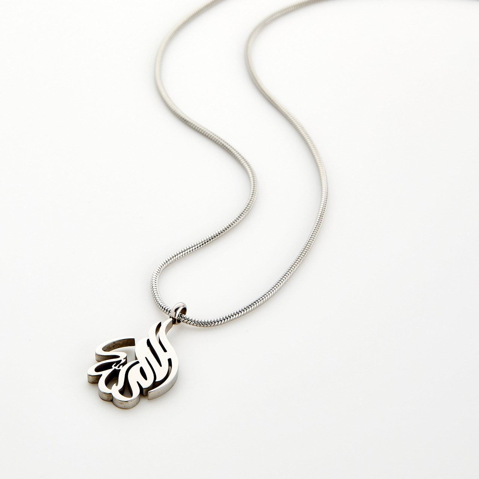 Silver calligraphy necklace spelling 'Alhamdulillah' on a chain, displayed on a white background.