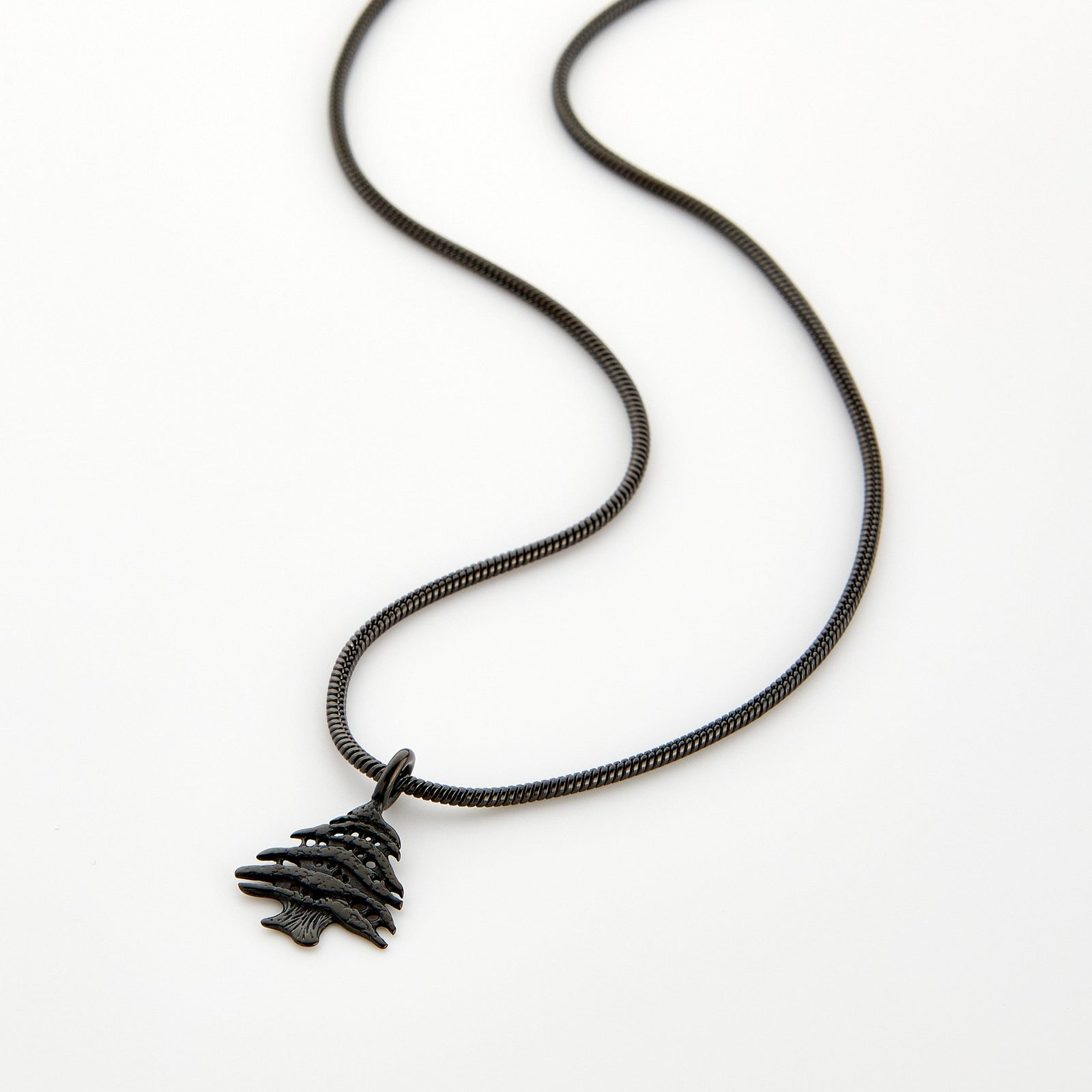 Black necklace with a Cedar of Lebanon tree pendant, displayed on a white background.