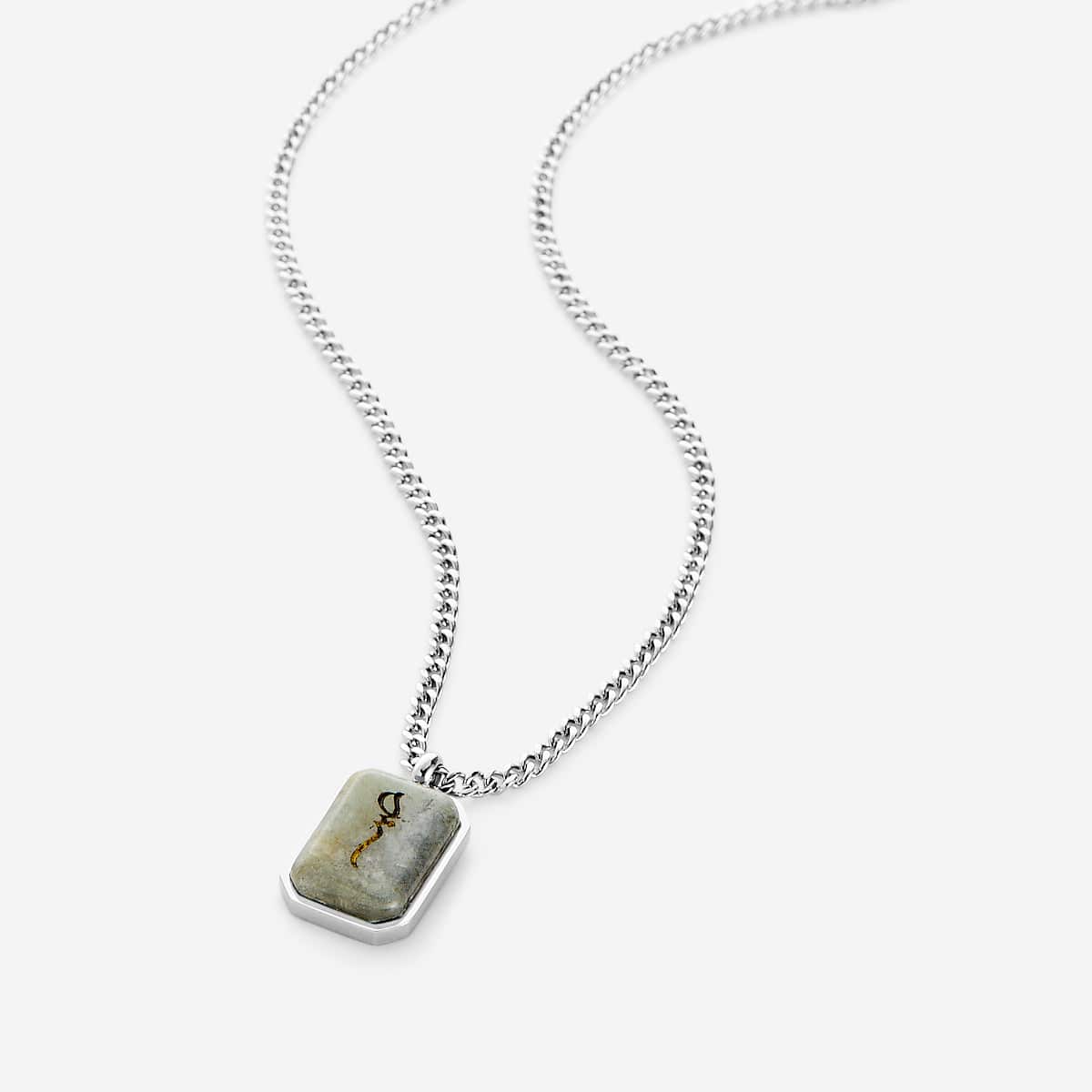 Silver chain necklace with a rectangular labradorite stone pendant engraved in Arabic calligraphy reading "Sabr" (patience), featuring natural gray and gold-toned stone variations, displayed on a white background.