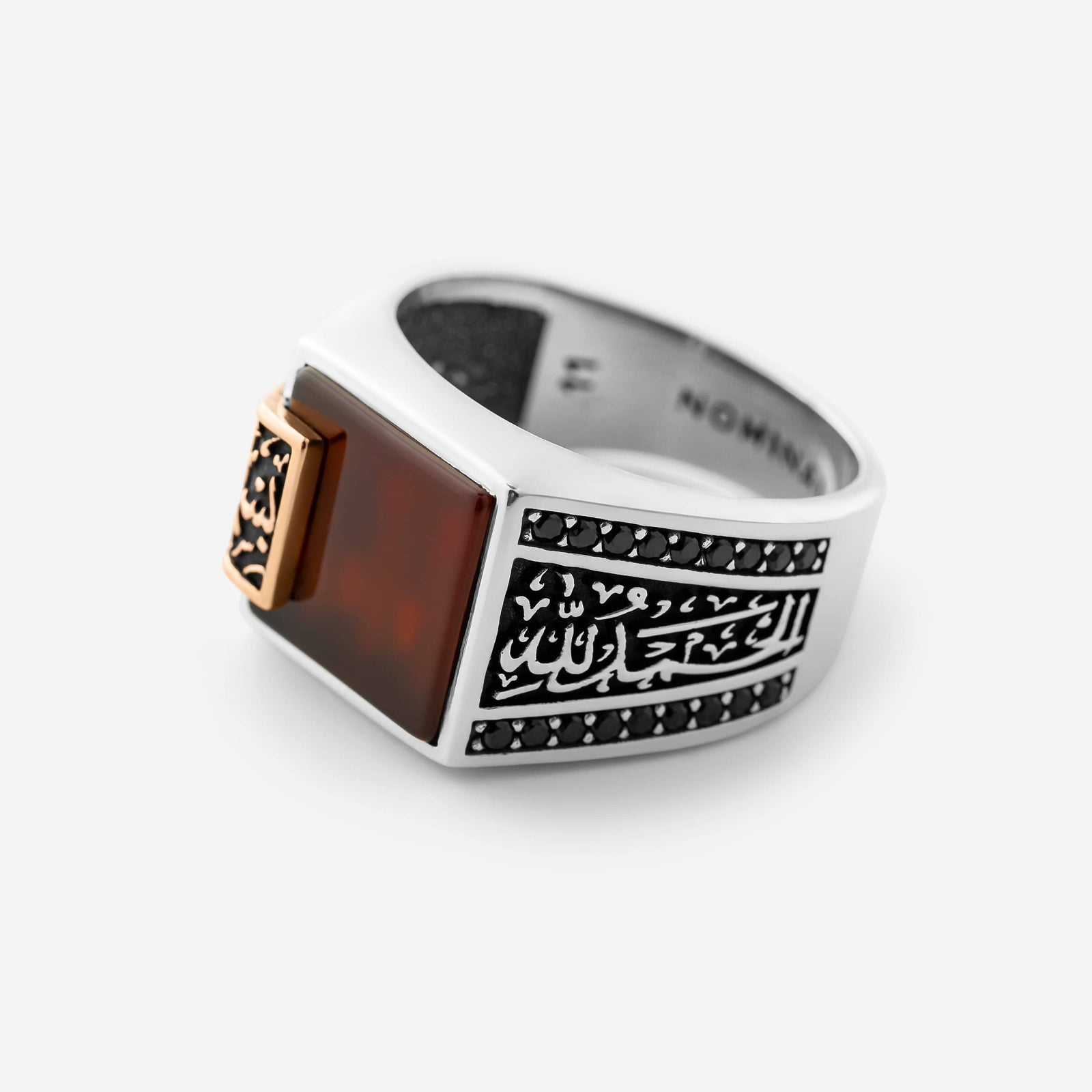 Close up of the Bismillah, Alhamdulillah Agate Sterling Silver Ring against a light background.