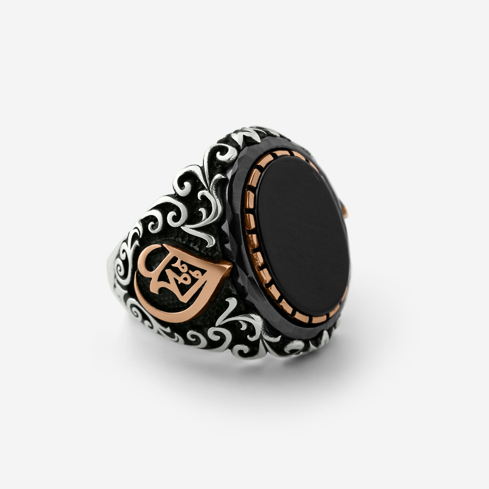 Close up of the Allah Onyx Sterling Silver Ring against a light background.