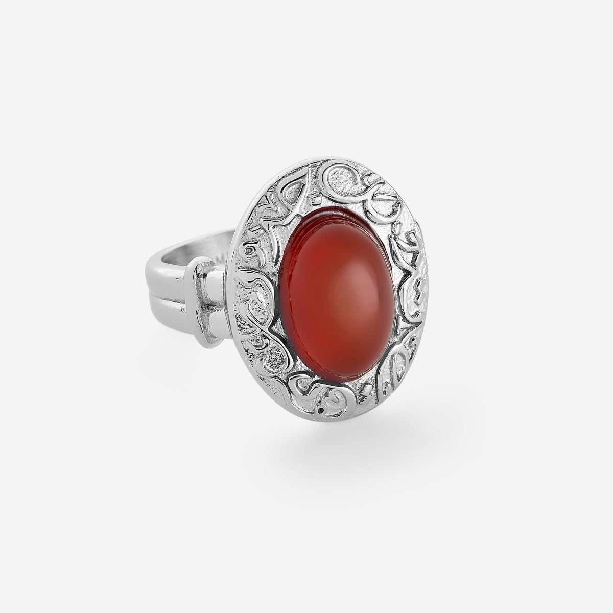 Silver ring with a deep red agate stone sitting at its centered, with the bezel of the ring embossed with Arabic calligraphy that reads "Roots Don't Fade". 