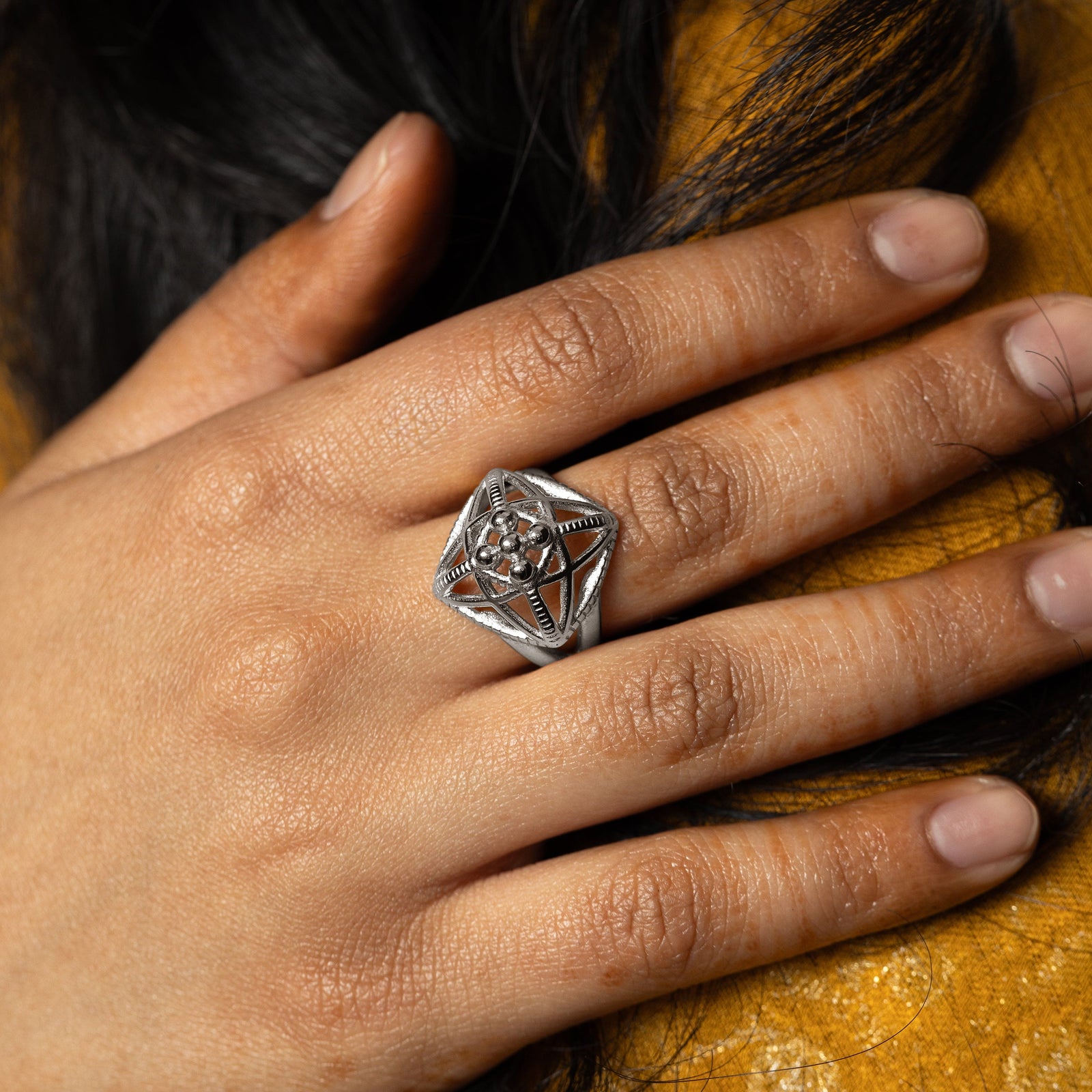 Close up photo of the silver Mahal ring as worn by the model.