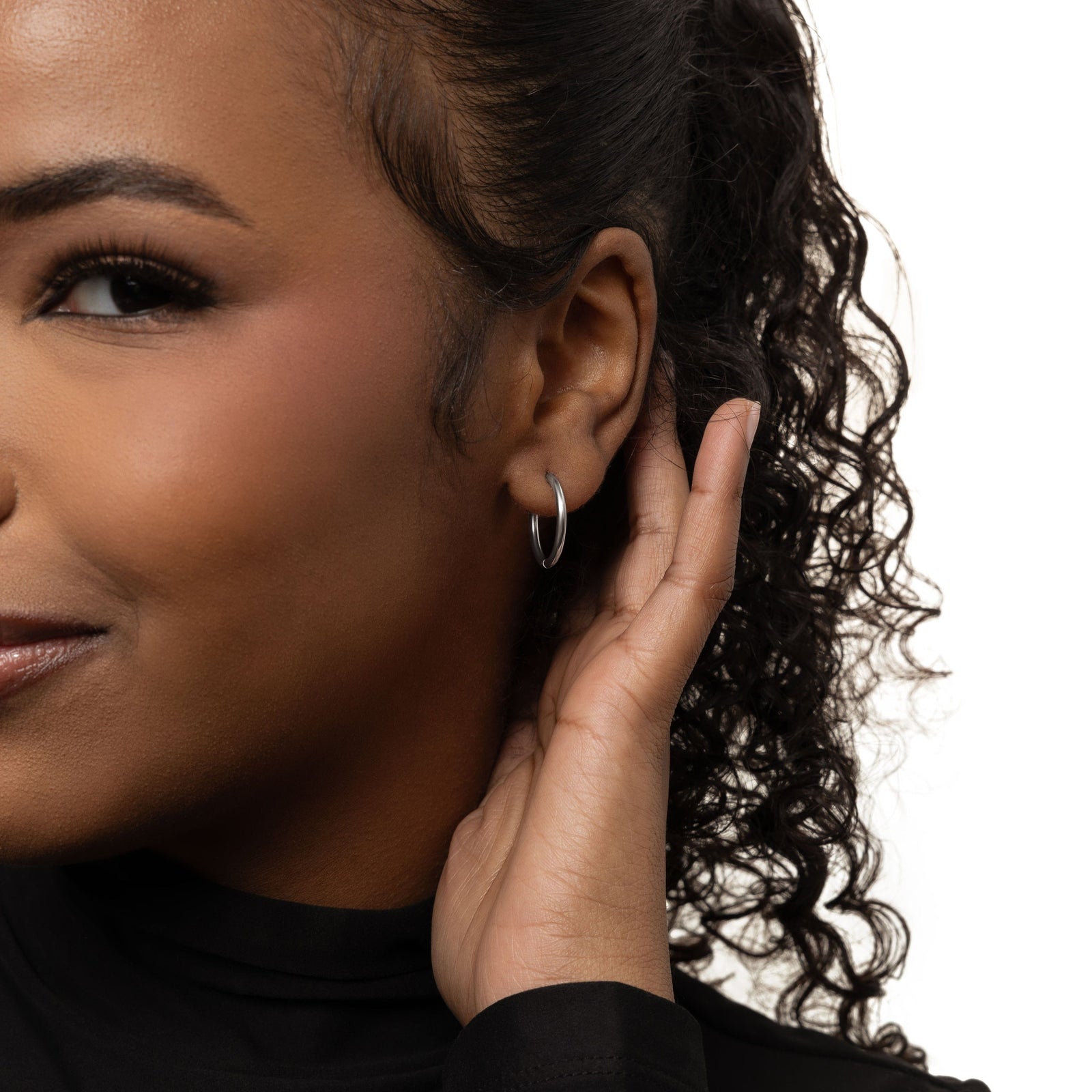 Close up of the silver Medium Essential Hoops | 16mm as worn by the model.