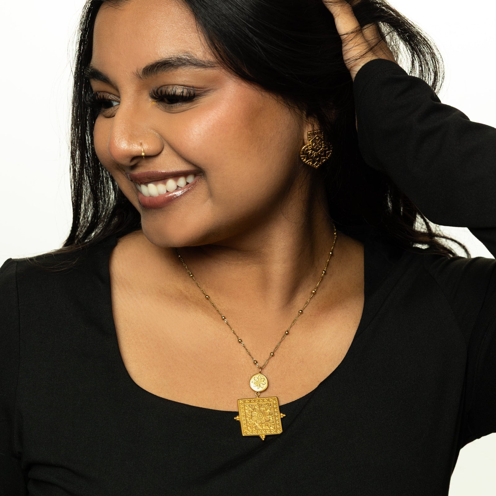 Woman wearing the Mehndi Floral Necklace, styled with a black top.
