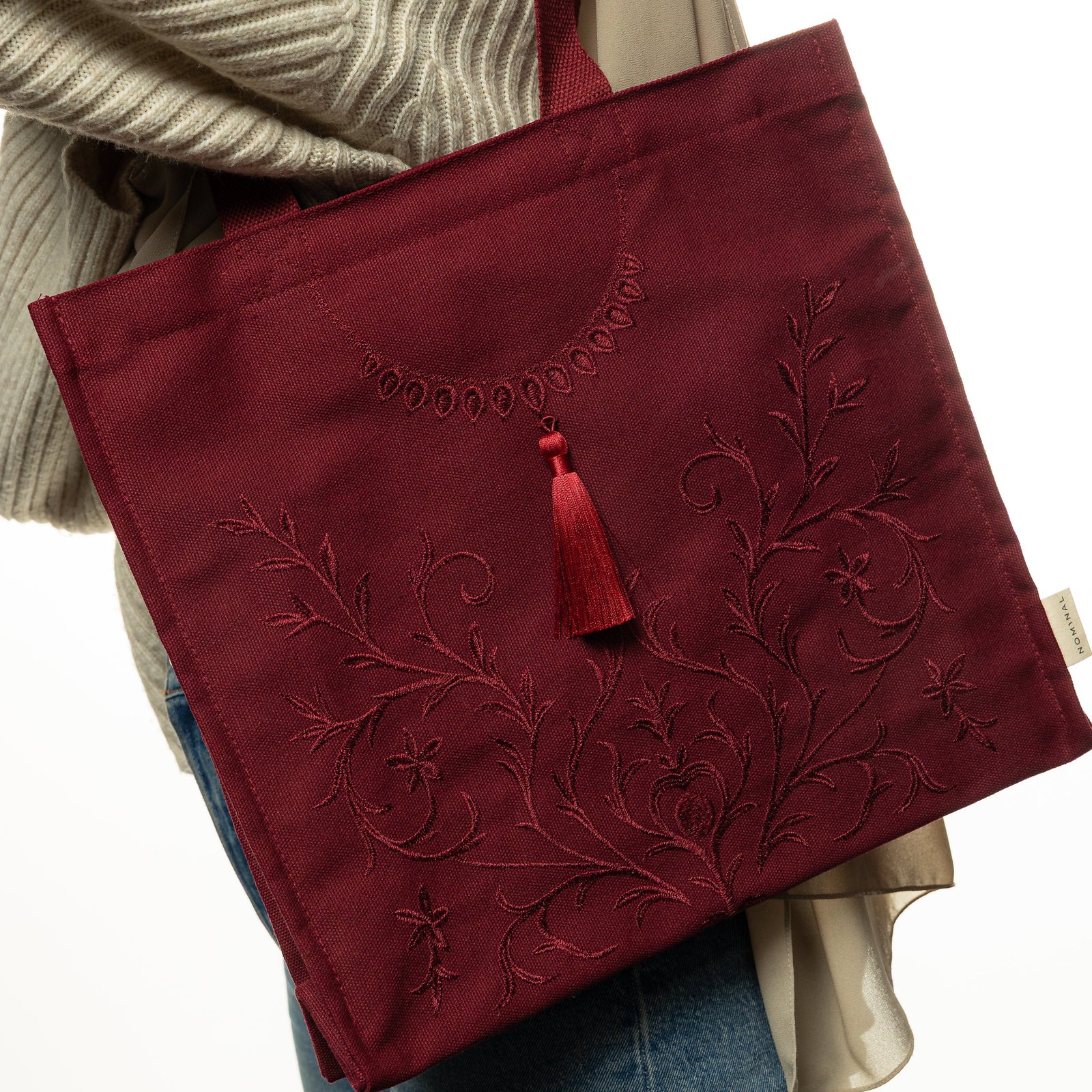 Photo of the maroon Mehndi Floral Tote carried by a model.