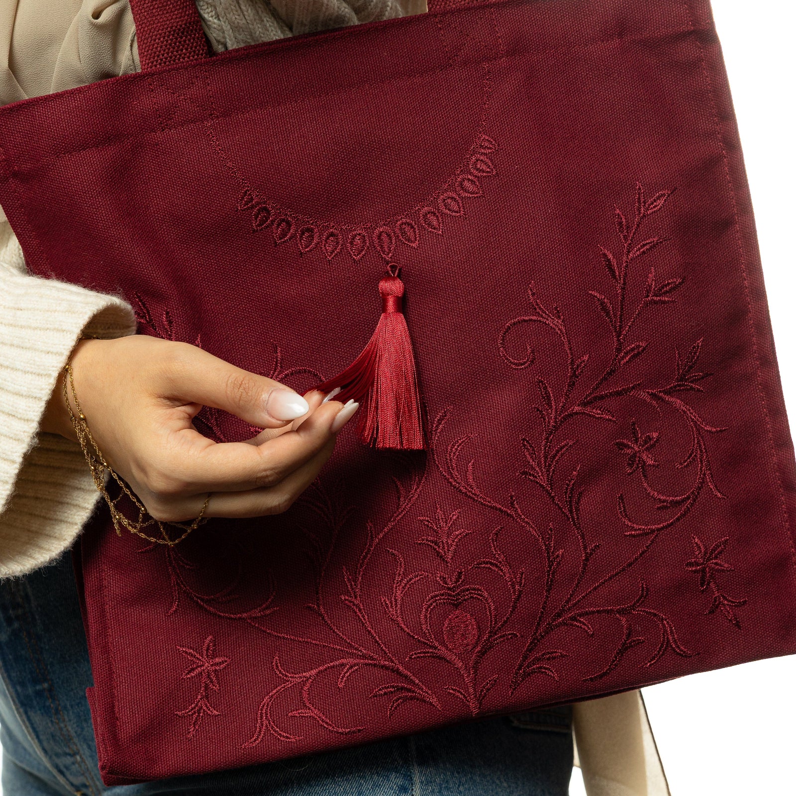 Model holding the end tassels of the bag.
