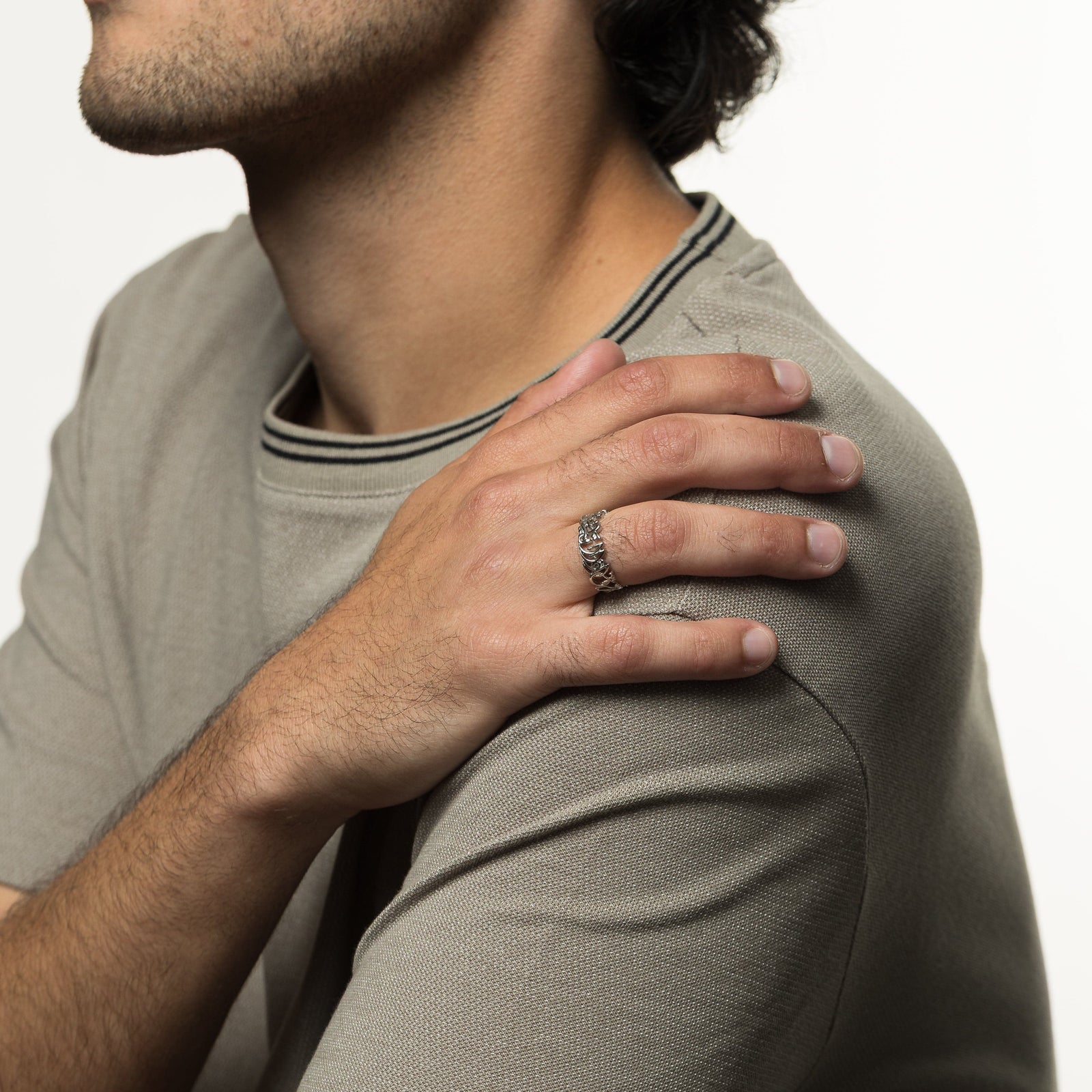 Model's right hand on their left shoulder. The model is wearing the silver "Walk to Me and I'll Run to You" Calligraphy Ring | Men on their right ring finger.