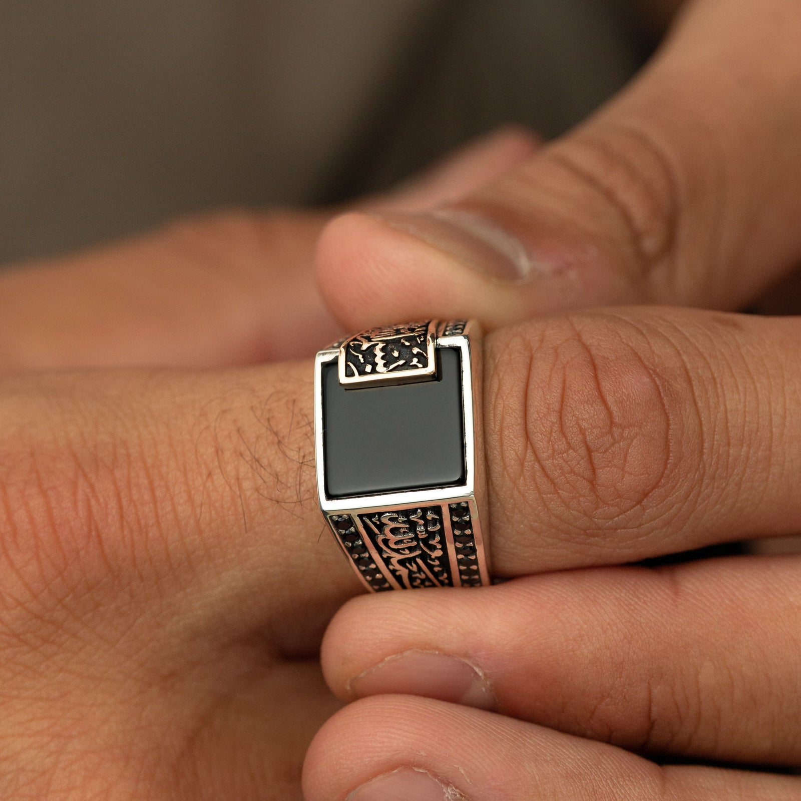 Close up of the "Bismillah, Alhamdulillah" Black Onyx Ring | Men as worn by the model.