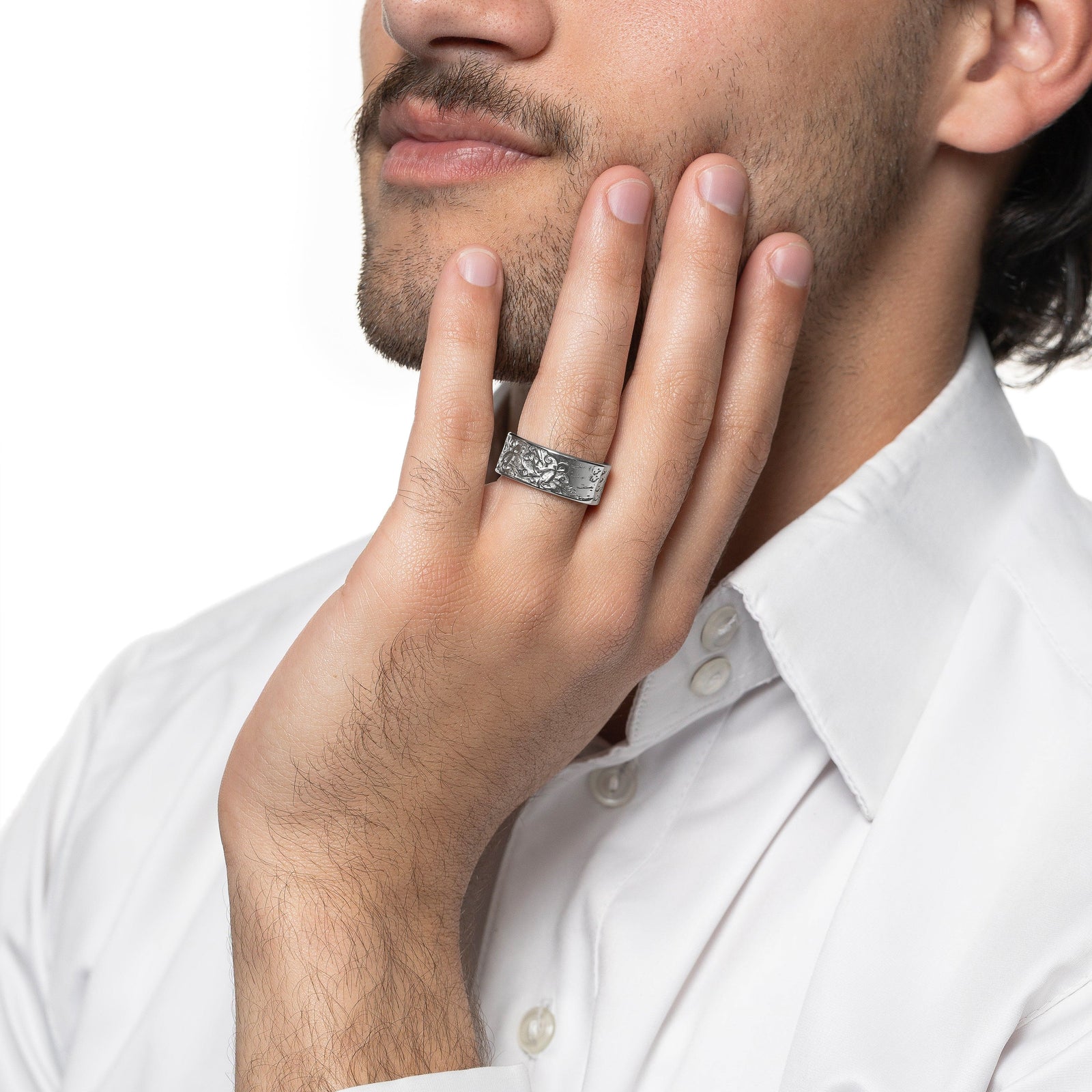 Model touches their face with their left hand. The model is wearing the silver Be Happy About Today Poem Ring on their left ring finger.