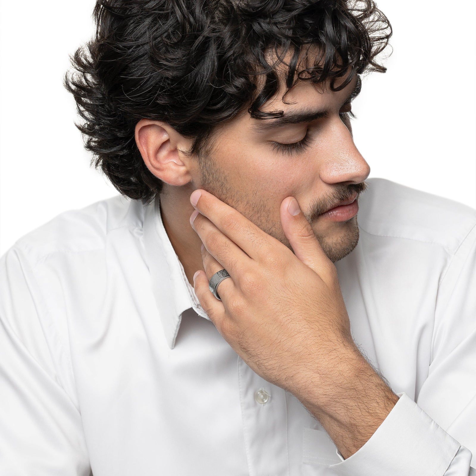 Model touches their face with their left hand. The model is wearing the silver Be Happy About Today Poem Ring on their left ring finger.