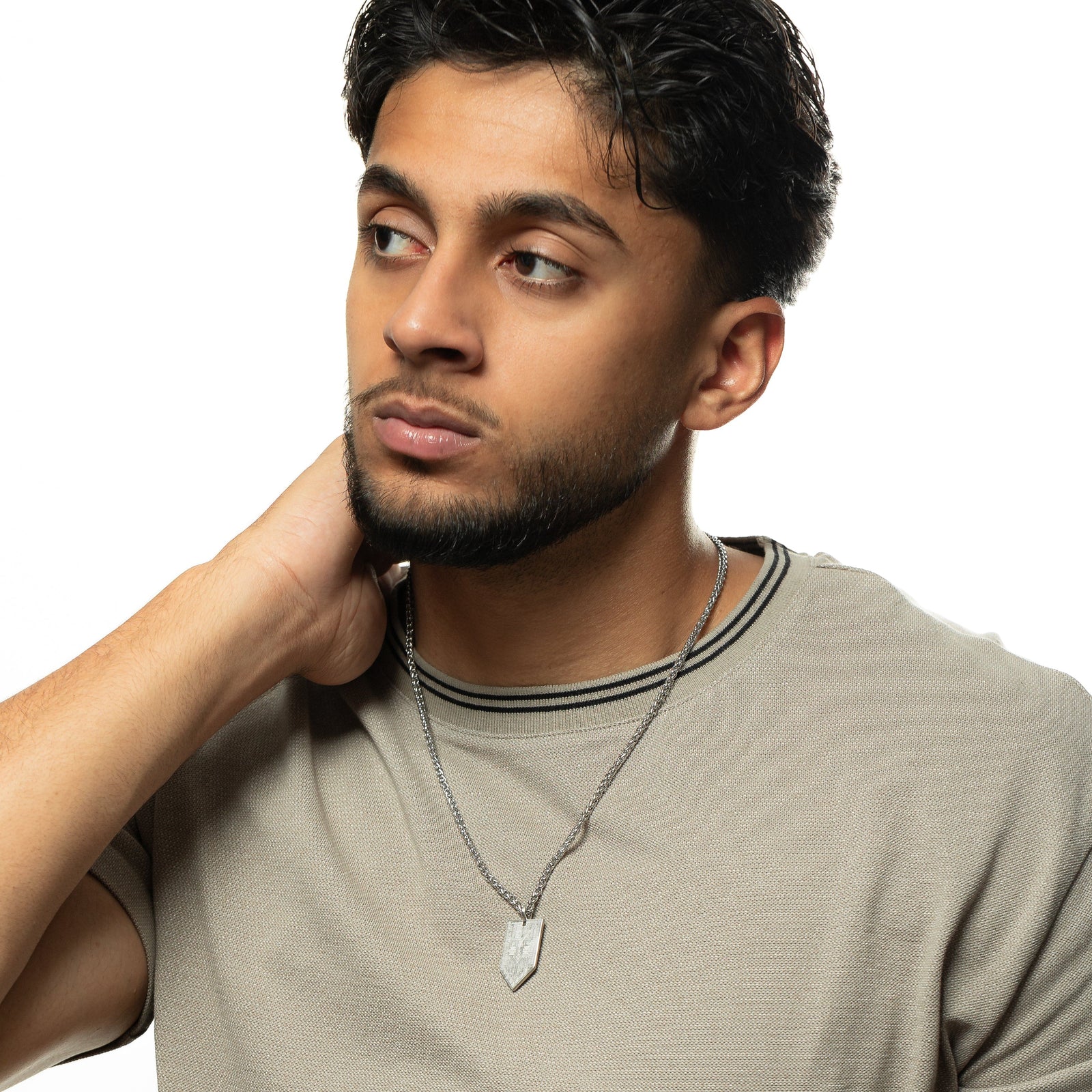 Man wearing the Hanging Tatreez Necklace | Men, showing the silver Tatreez pendant hanging at chest level.